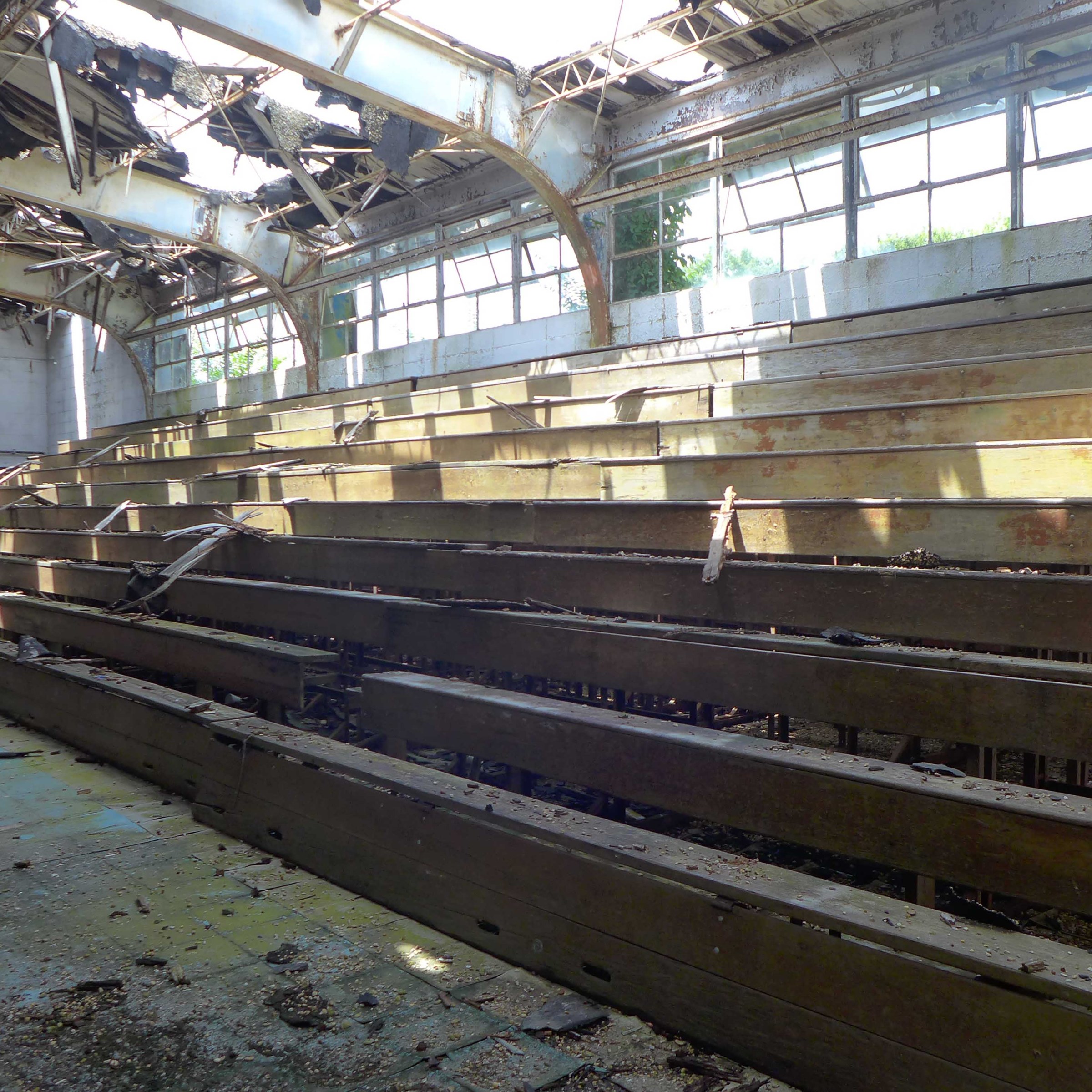 Photo of broken down bleachers in empty school gym