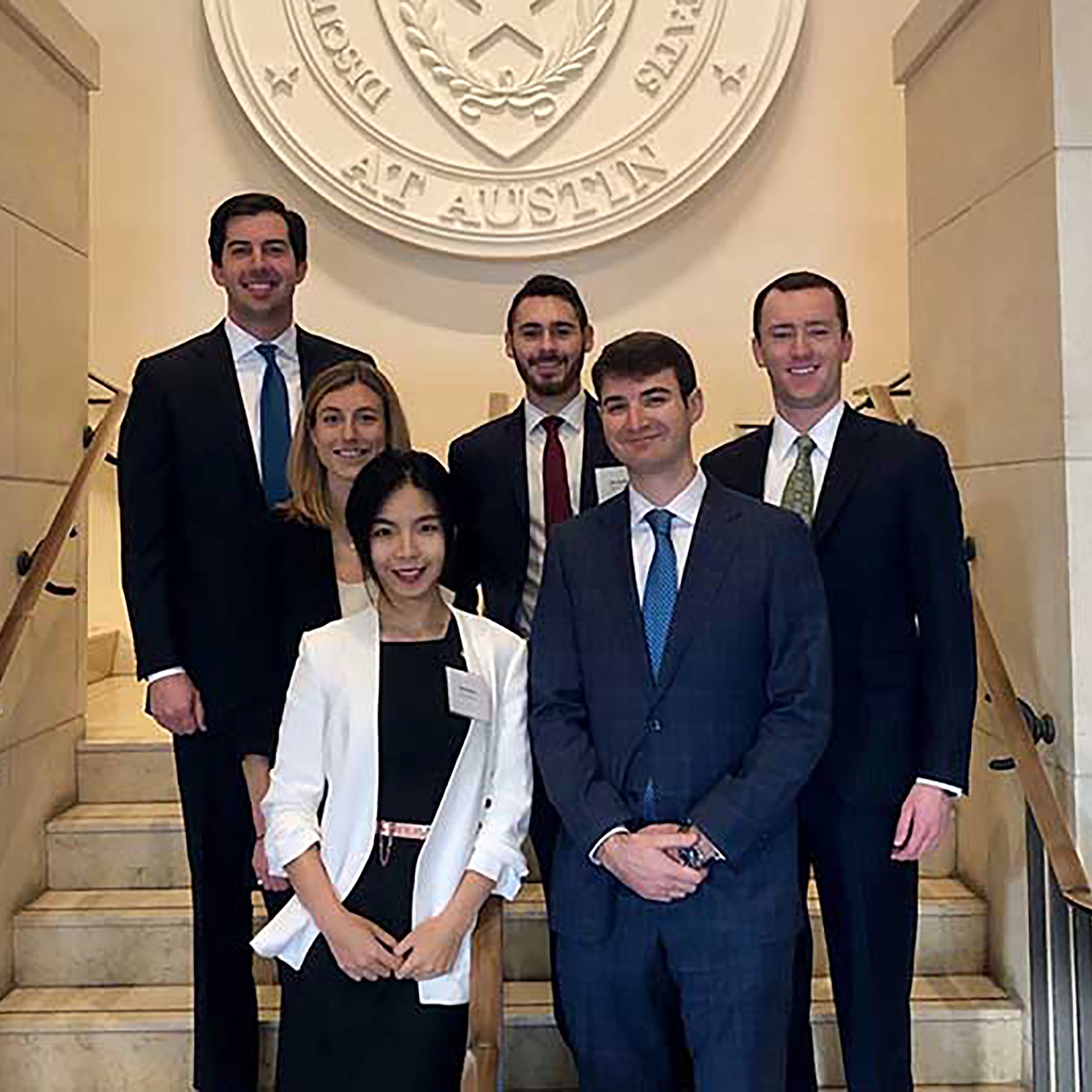 Photo of six students posing on marble staircase