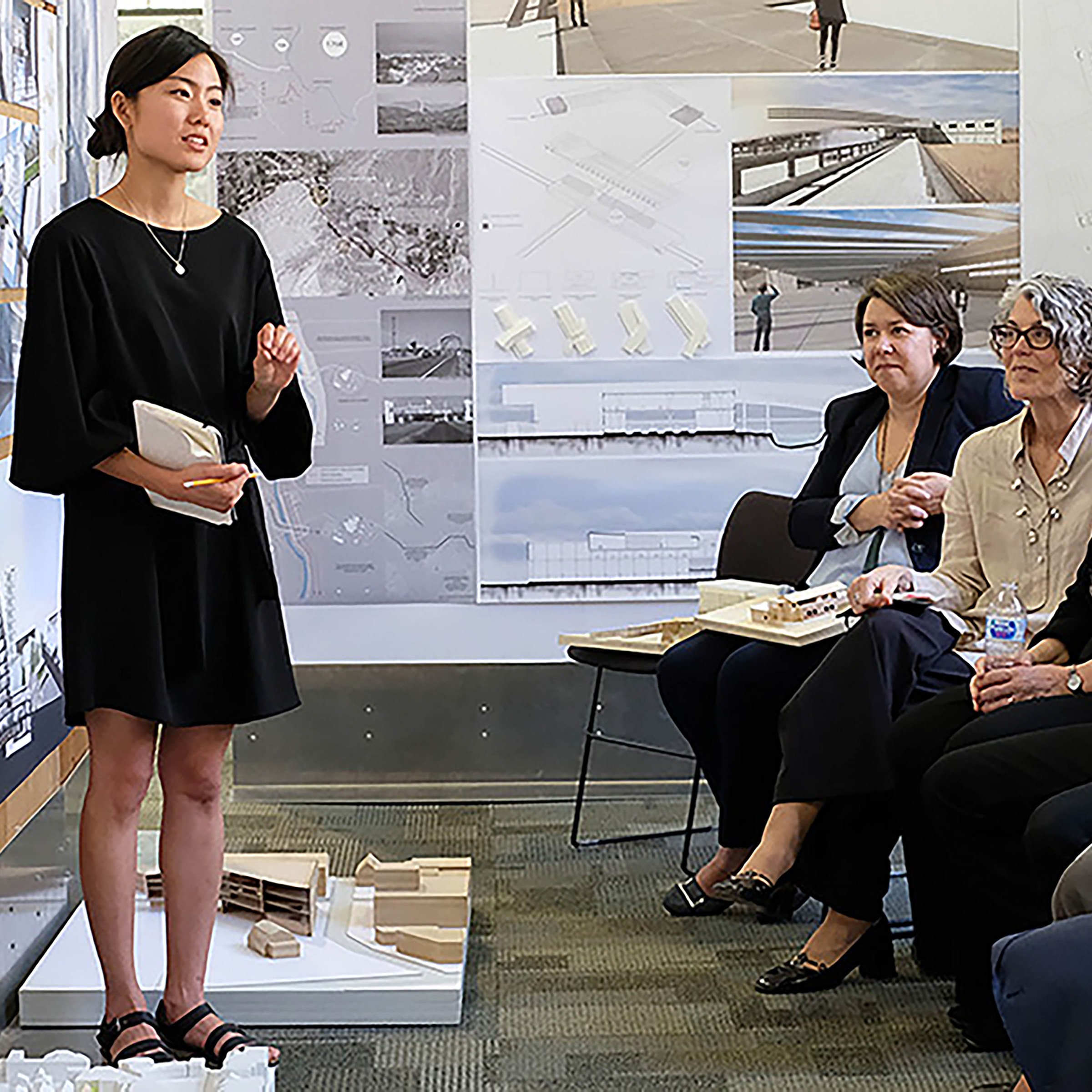 Photo of woman presenting proposal to audience