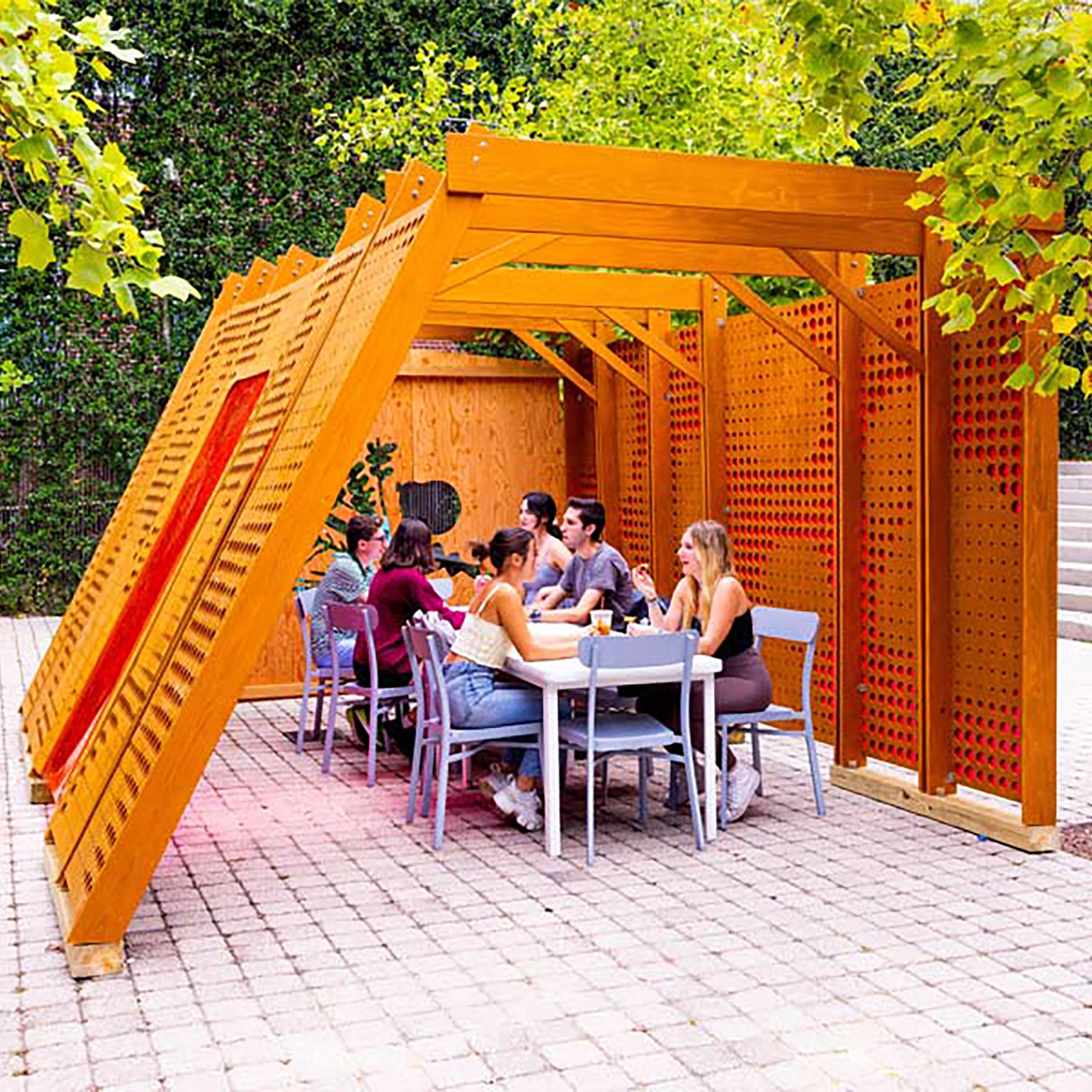 Students sitting in modern Sukkah 