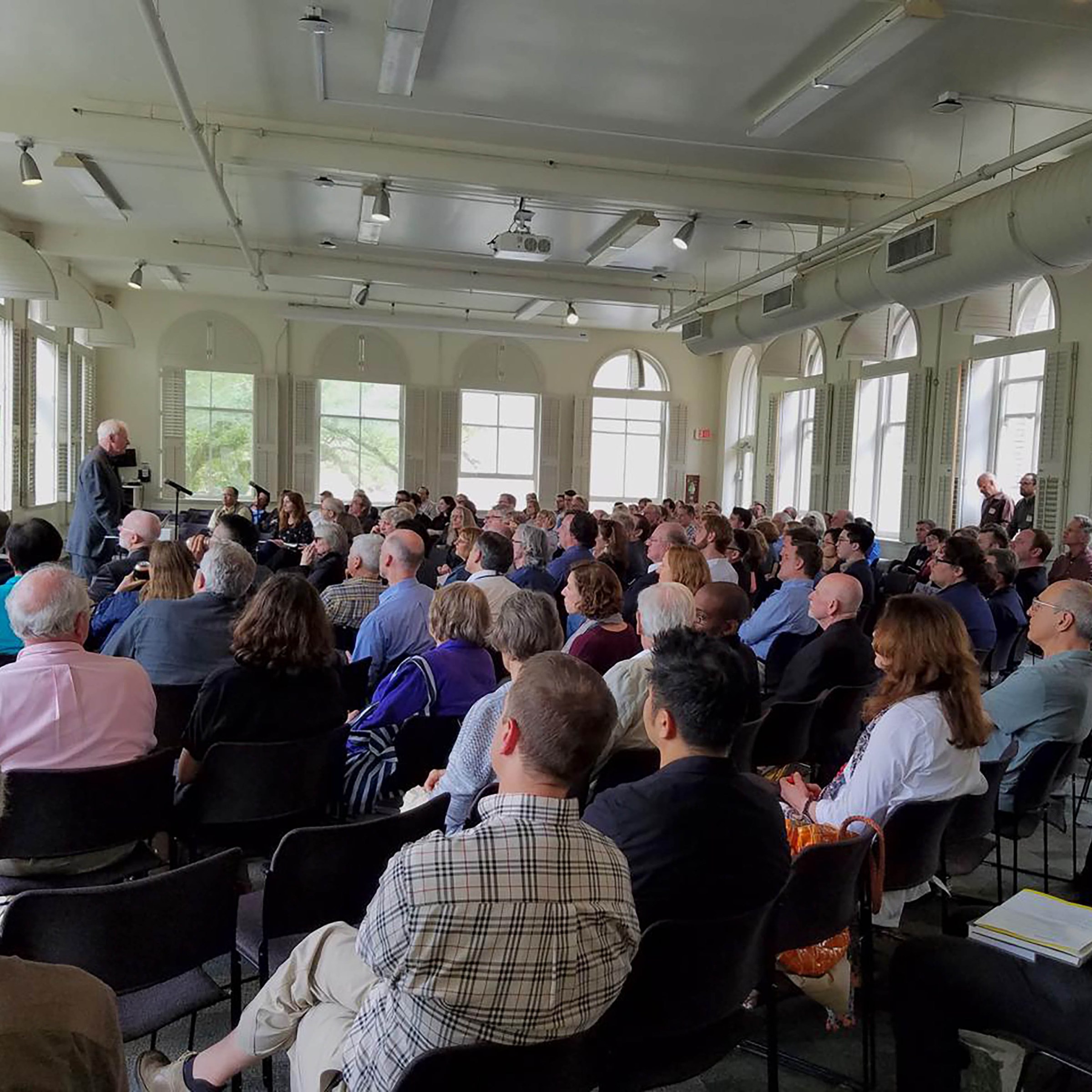 Audience watching lecture by professor in front of the room 