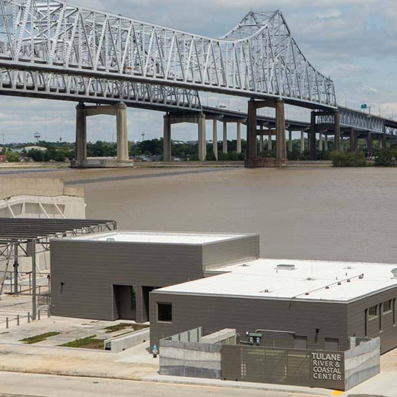 Photo of Tulane River Coastal Center and bridge in the background 