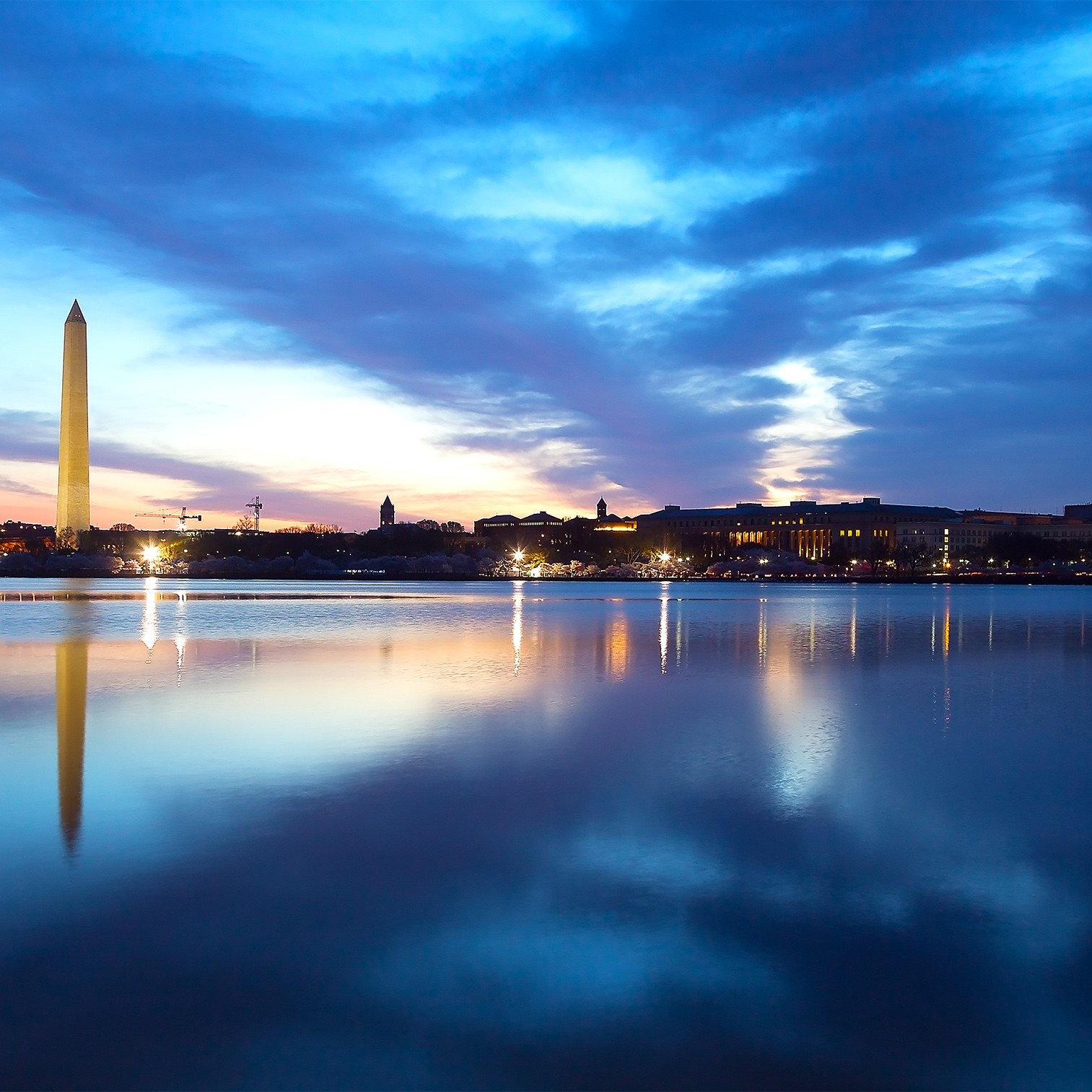 Washington D.C. skyline at sunset with Potomac River in the foreground.