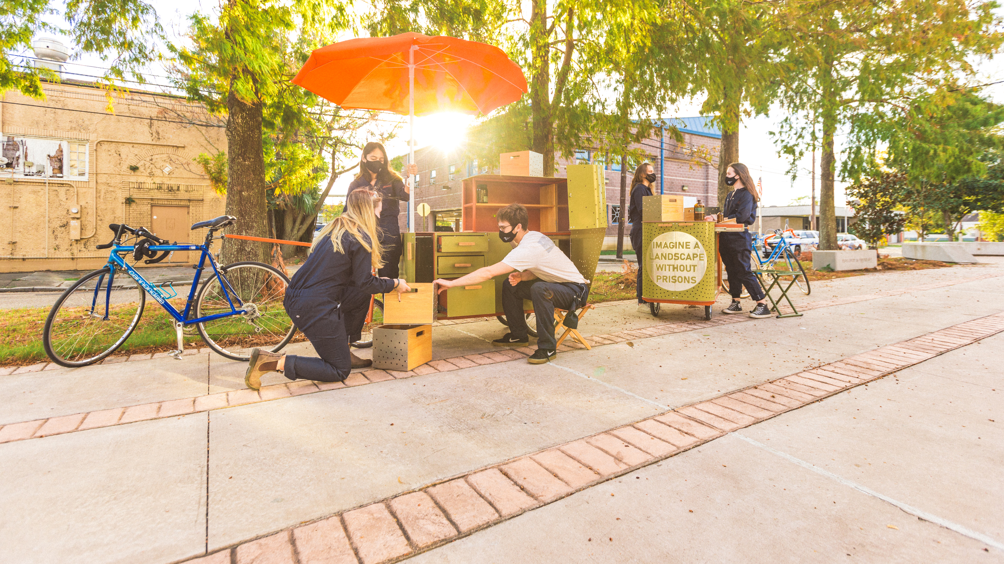 Photo of a group of students using the drawers and features of two bike-drive carts, called apothecarts.