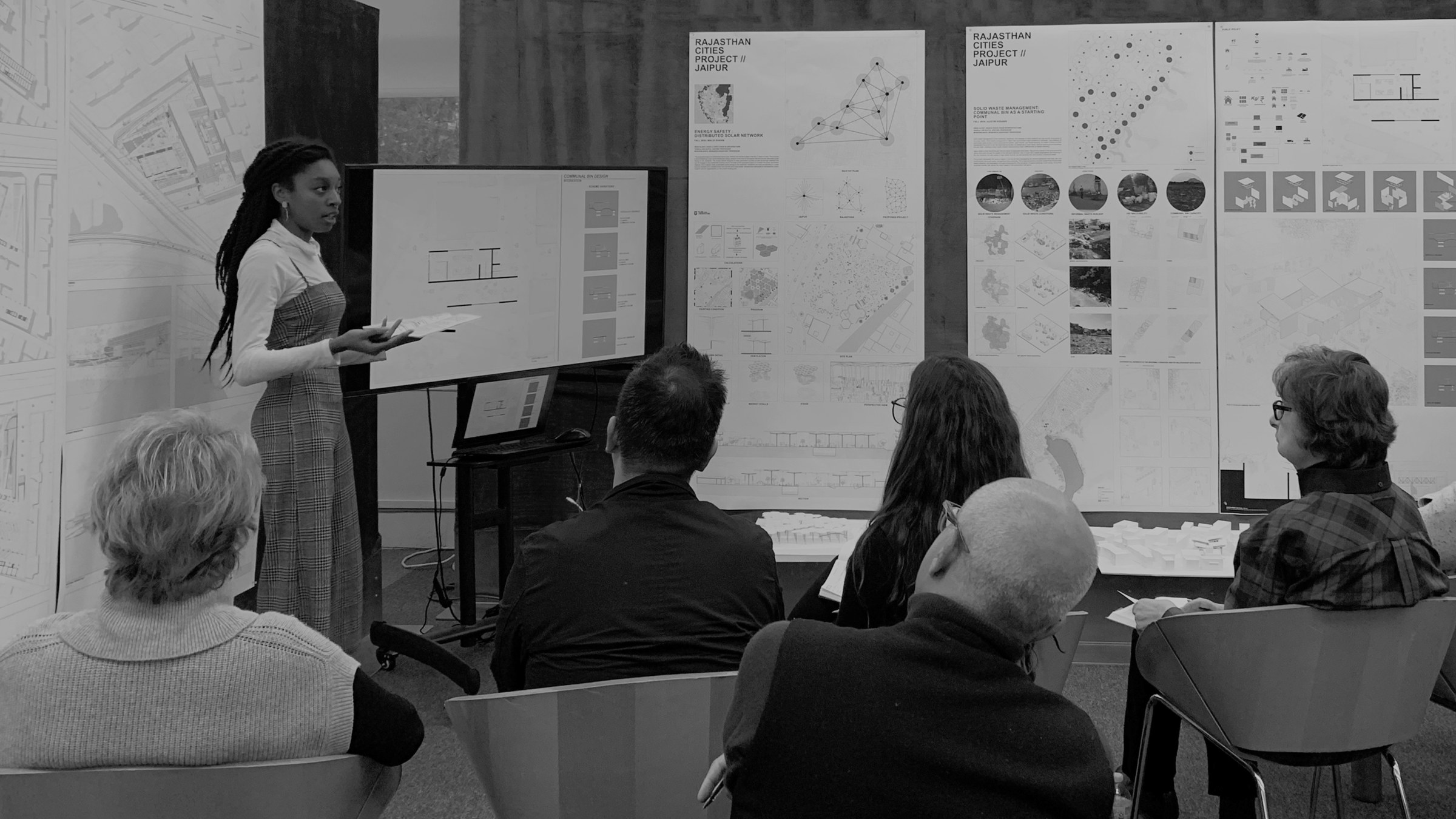 Architecture student giving a presentation to a panel of judges
