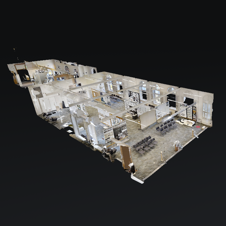 Dollhouse/axonometric view of a digitally recreated large lecture hall with presentation boards and rows of chairs, stitched together from 360-degree photos