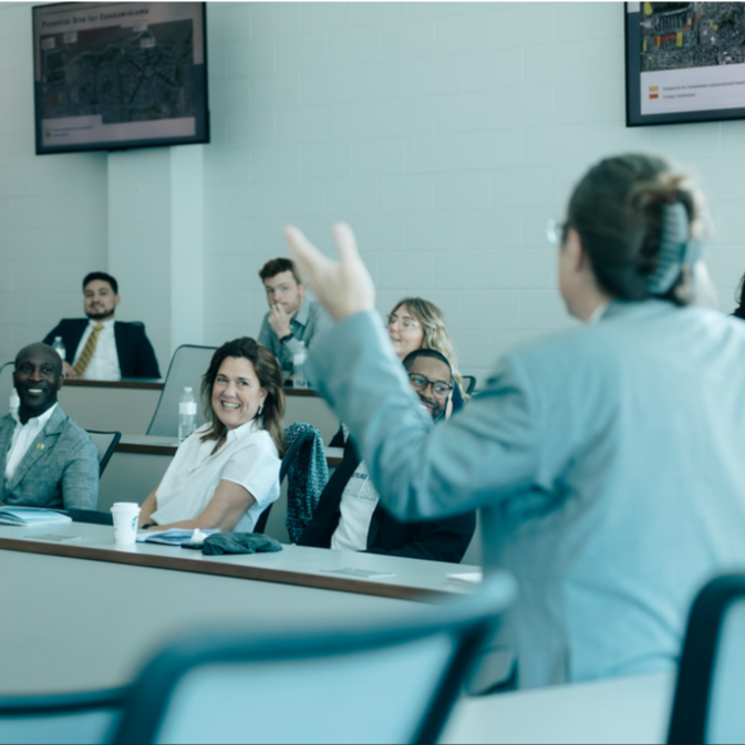 Photo of someone talking to a conference room 