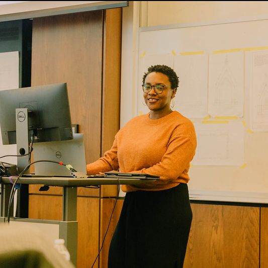 Person presenting from behind a lectern 