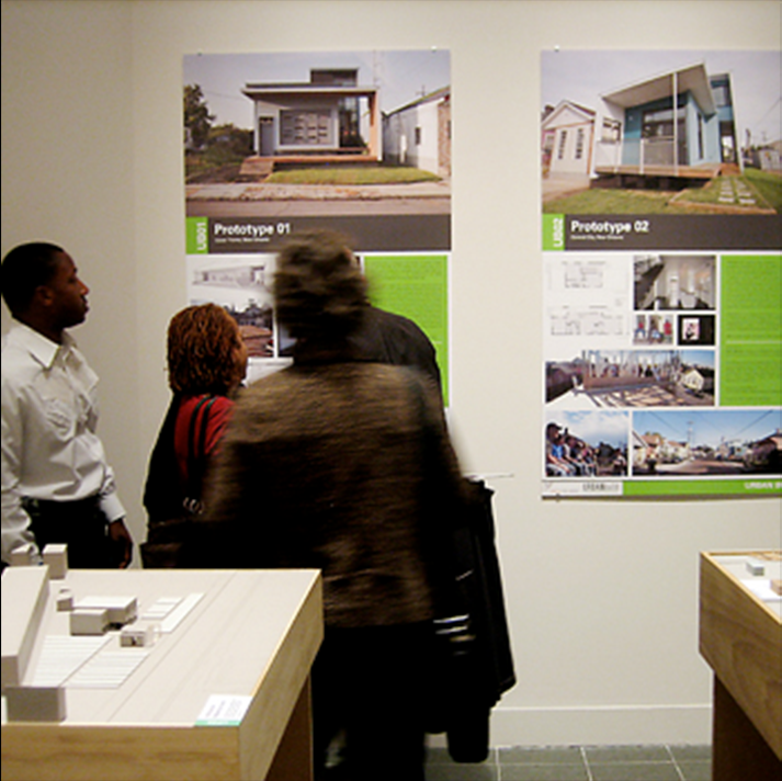 people gathering at posters of prototyped designs
