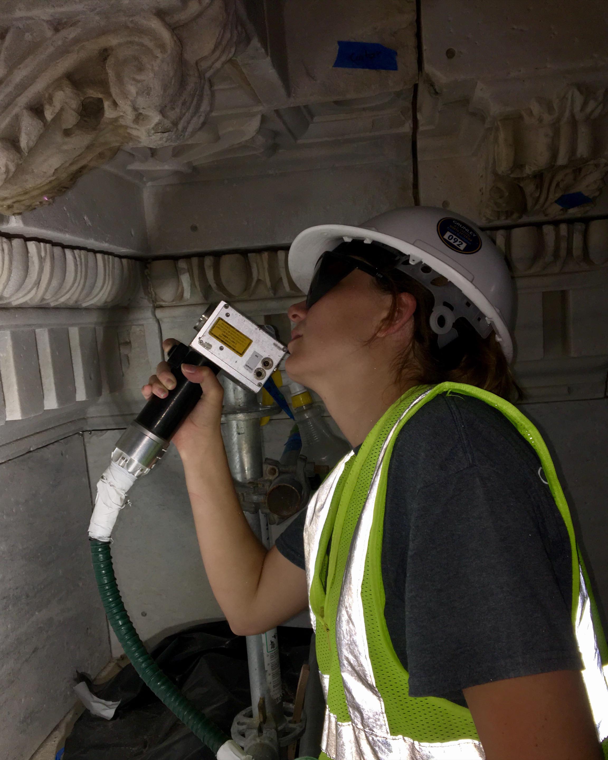 exterior image of Emma Kousouris working on a building