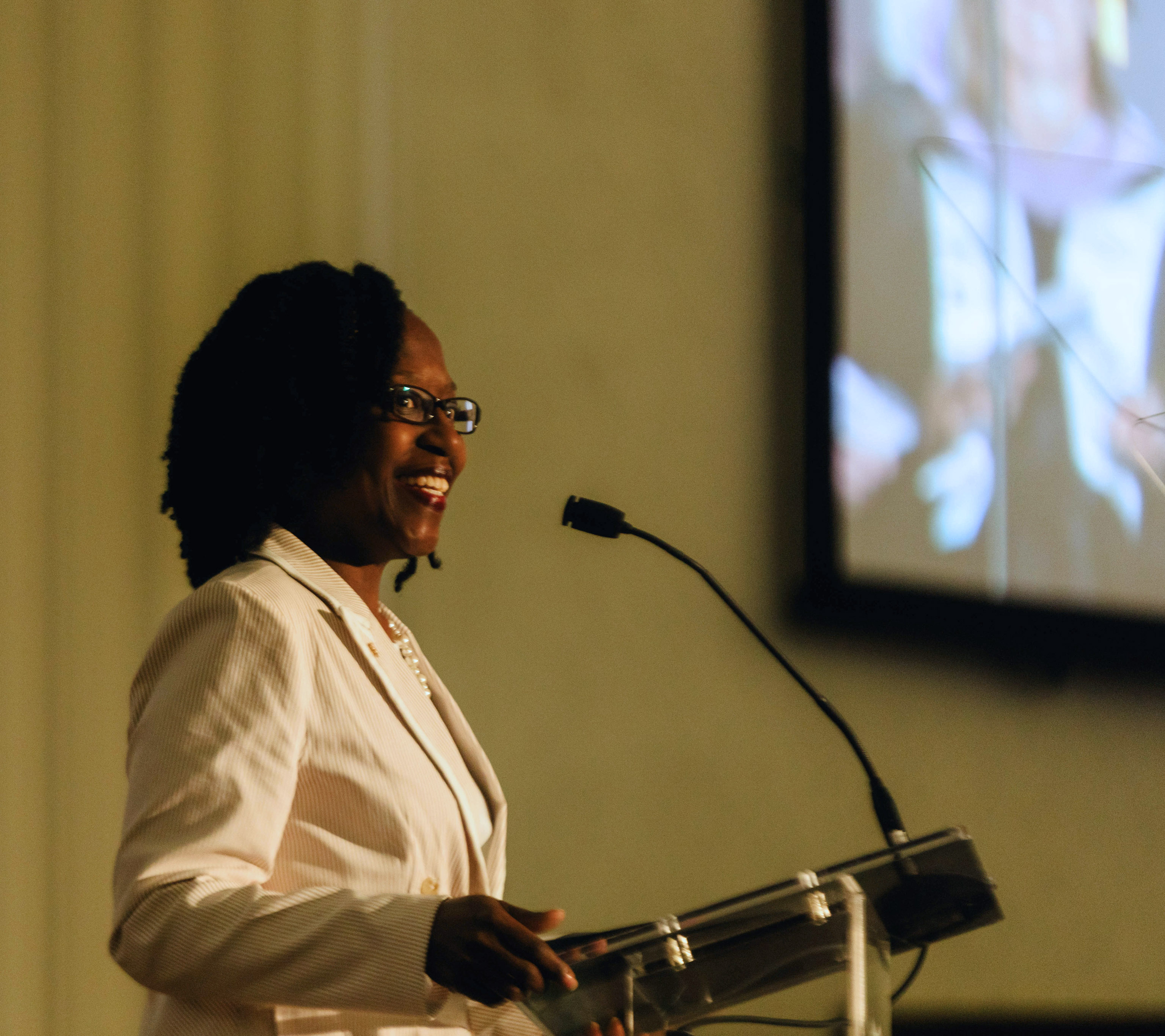 Close up shot of Nicole Hobson-Morris, alumni, giving a commencement speech at a podium.