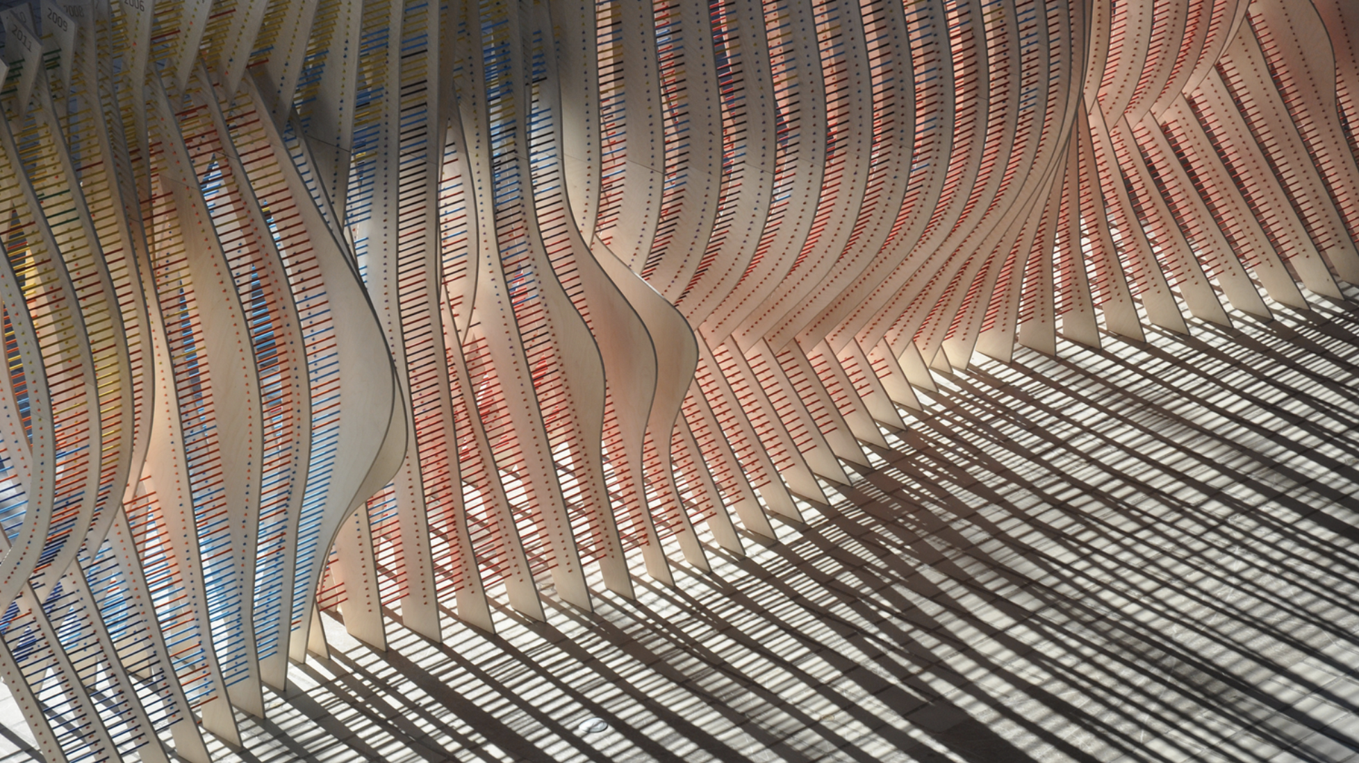 image of red, blue and tan wood sculpture 