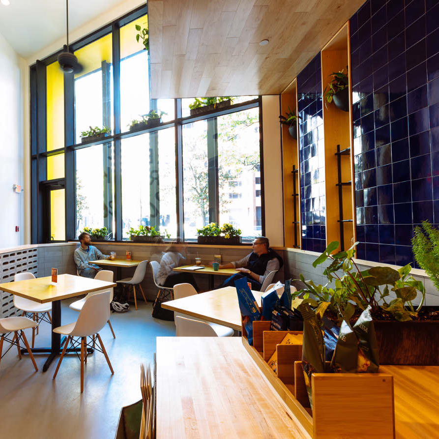 image of the inside of a restaurant, colorful interior, large windows