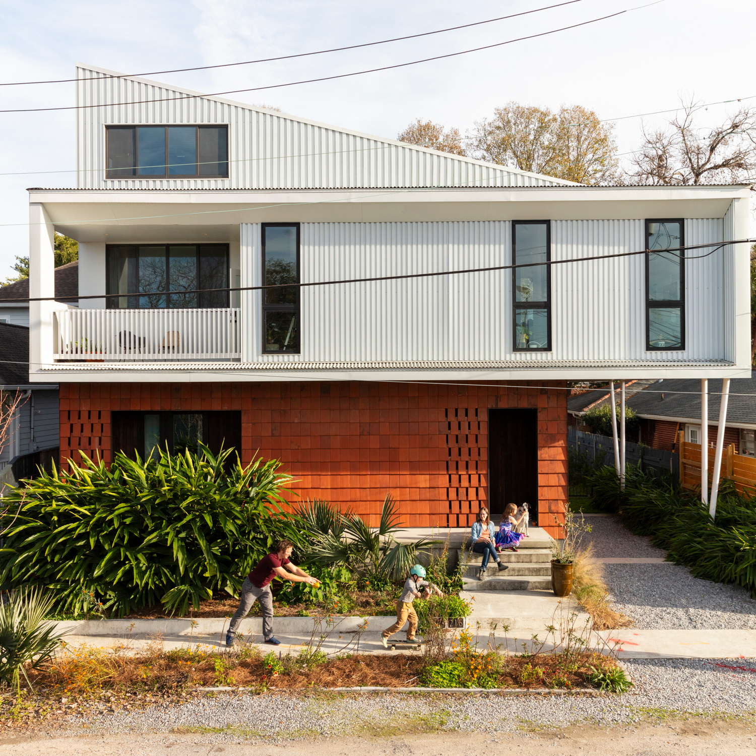 image of a white and orange brick house with three stories