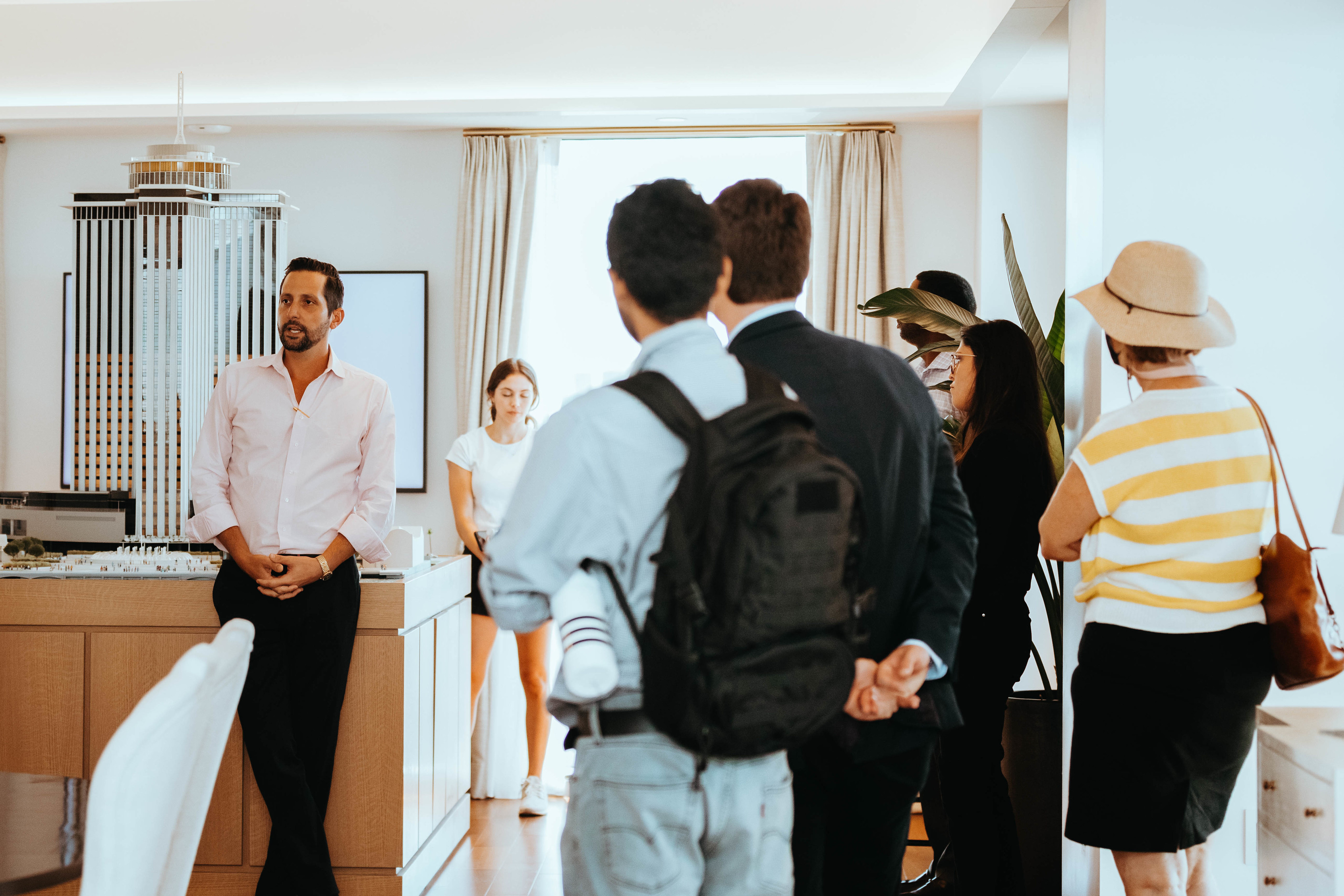 image of someone speaking in front of a group in an open room