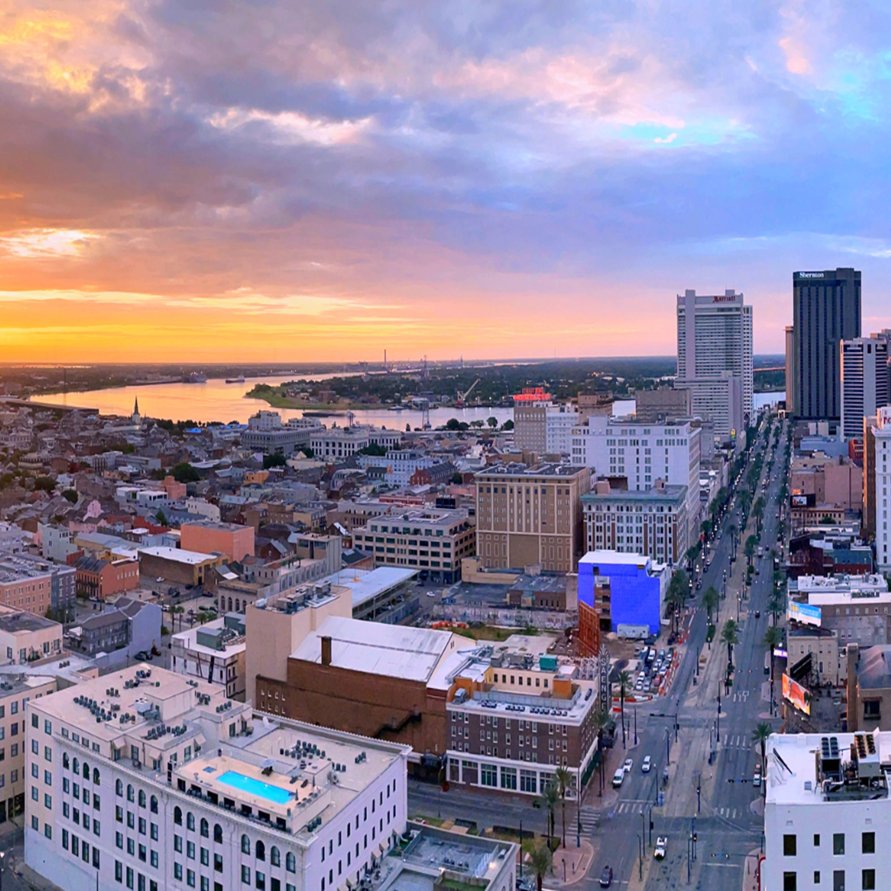 New Orleans city skyline with an orange sunset in the back