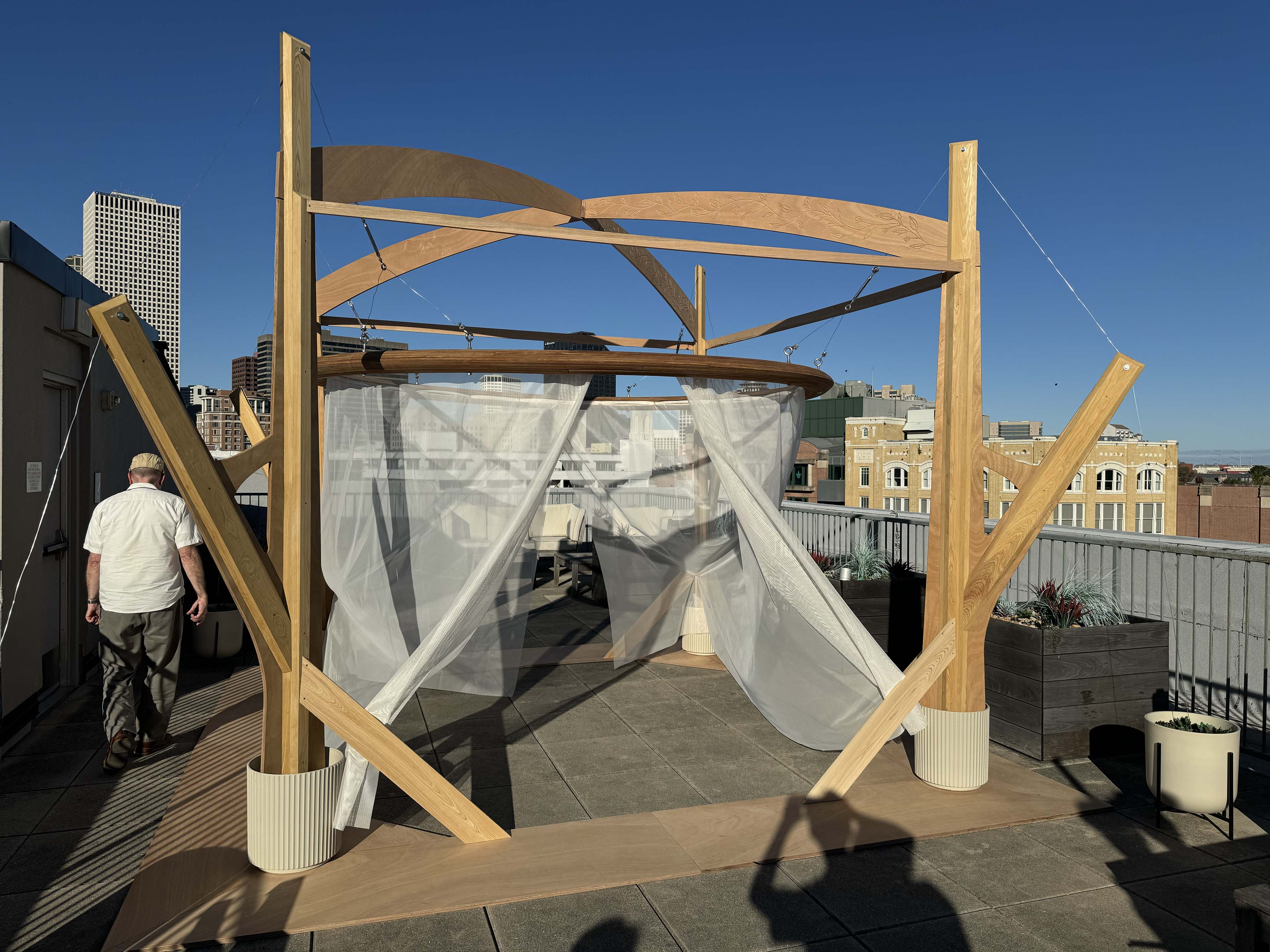 A Sukkah on a rooftop during the day.