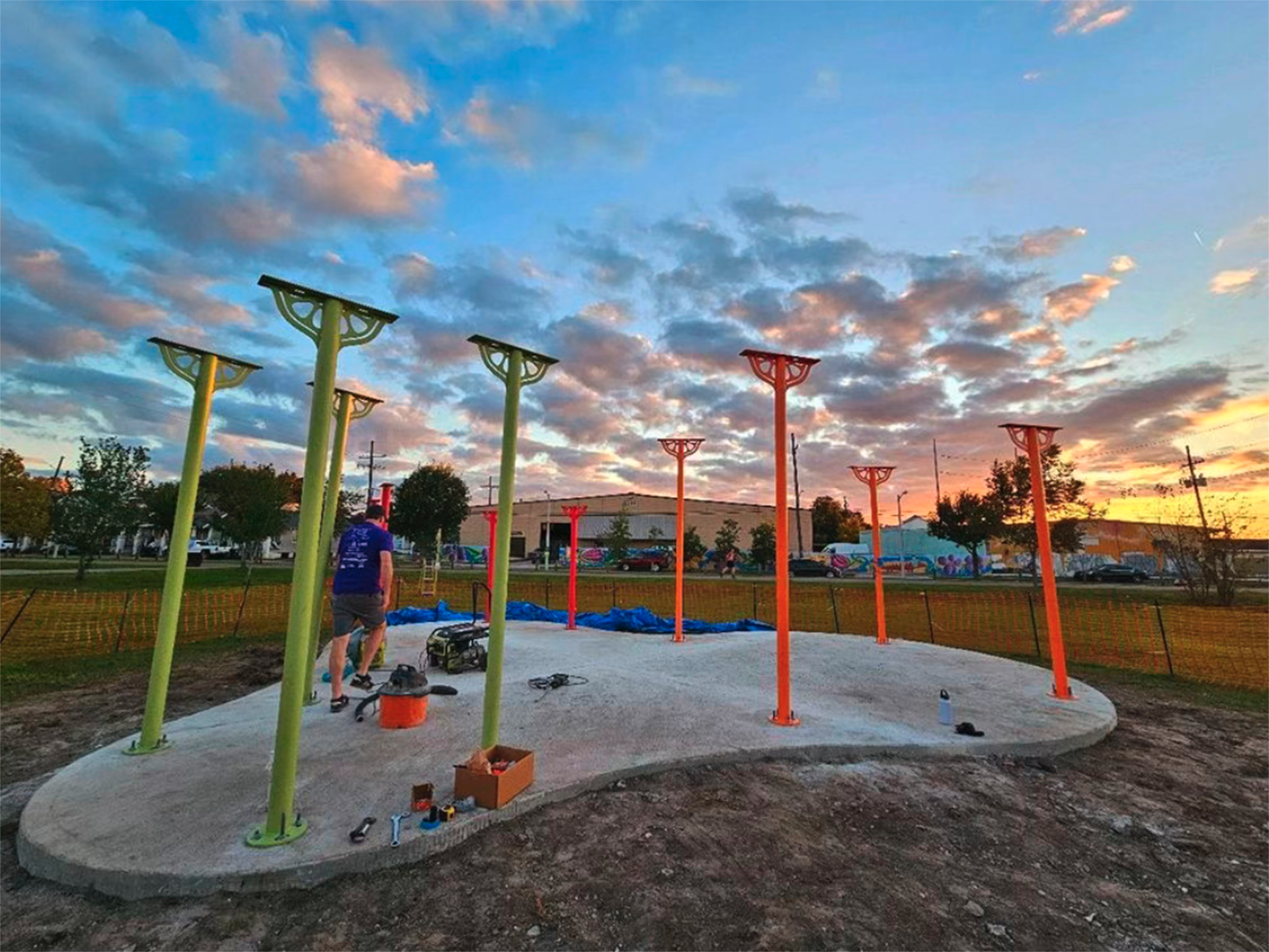 pillars for an outdoor pavilion are erected in a concrete slab, the future classroom and farmstand space for an urban farm nonprofit.