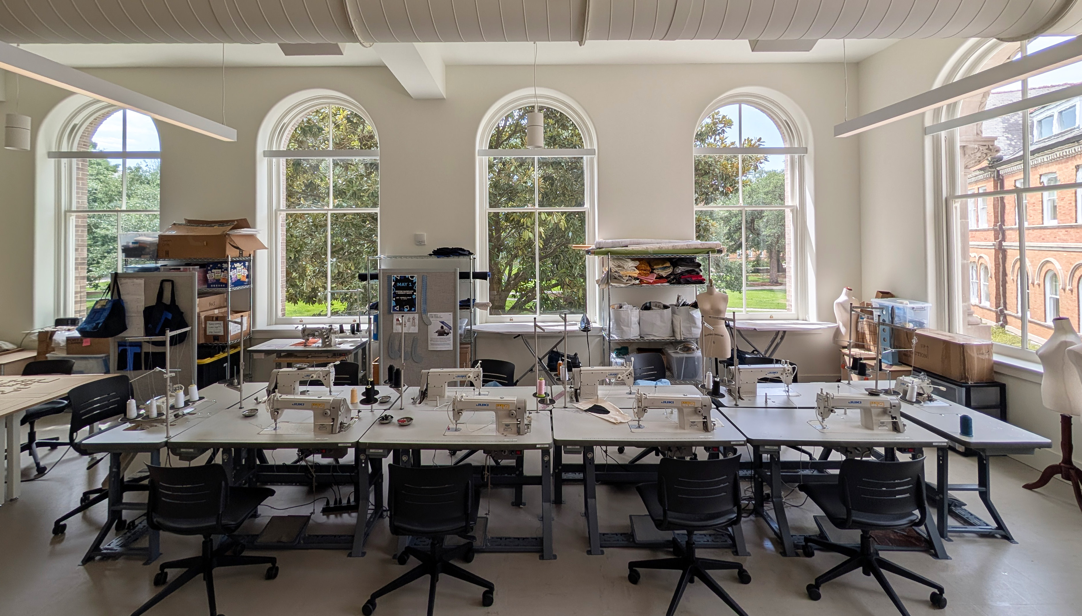one point perspective of the textile lab in RMH. view of sewing machines with arched windows as the backdrop.