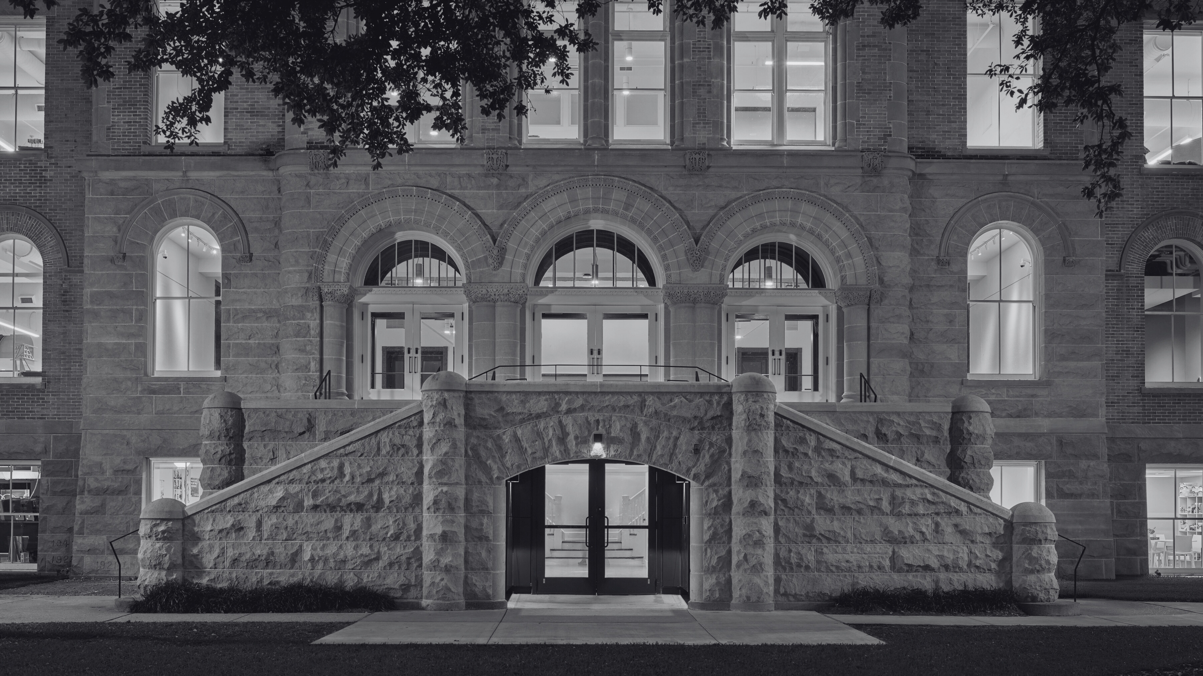 Exterior view of front facade of Richardson Memorial Hall, slightly close up to only see the first two floors and the main entrance in the middle.