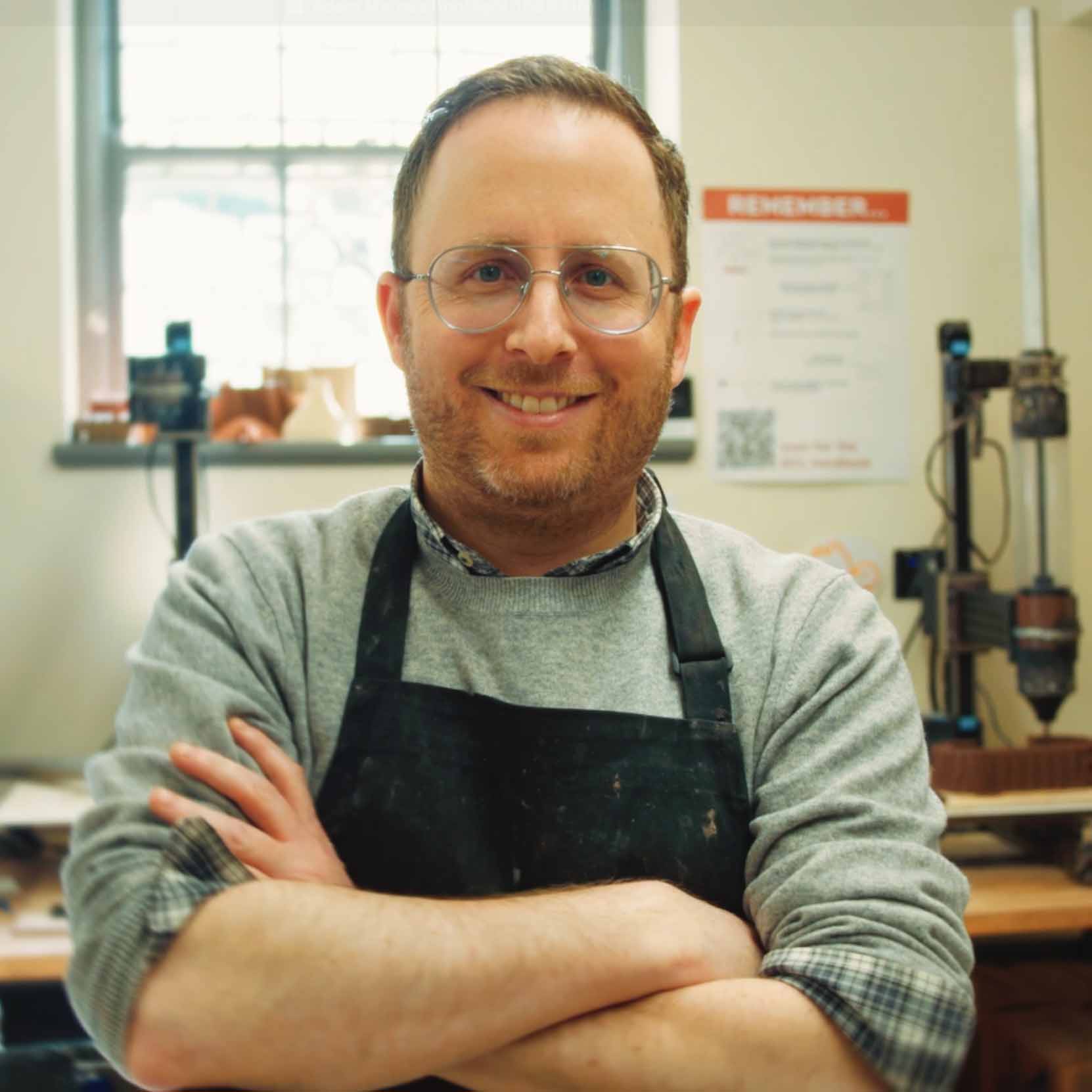 Portrait of Adam Marcus standing in Tulane's digital-ceramics fabrication lab.