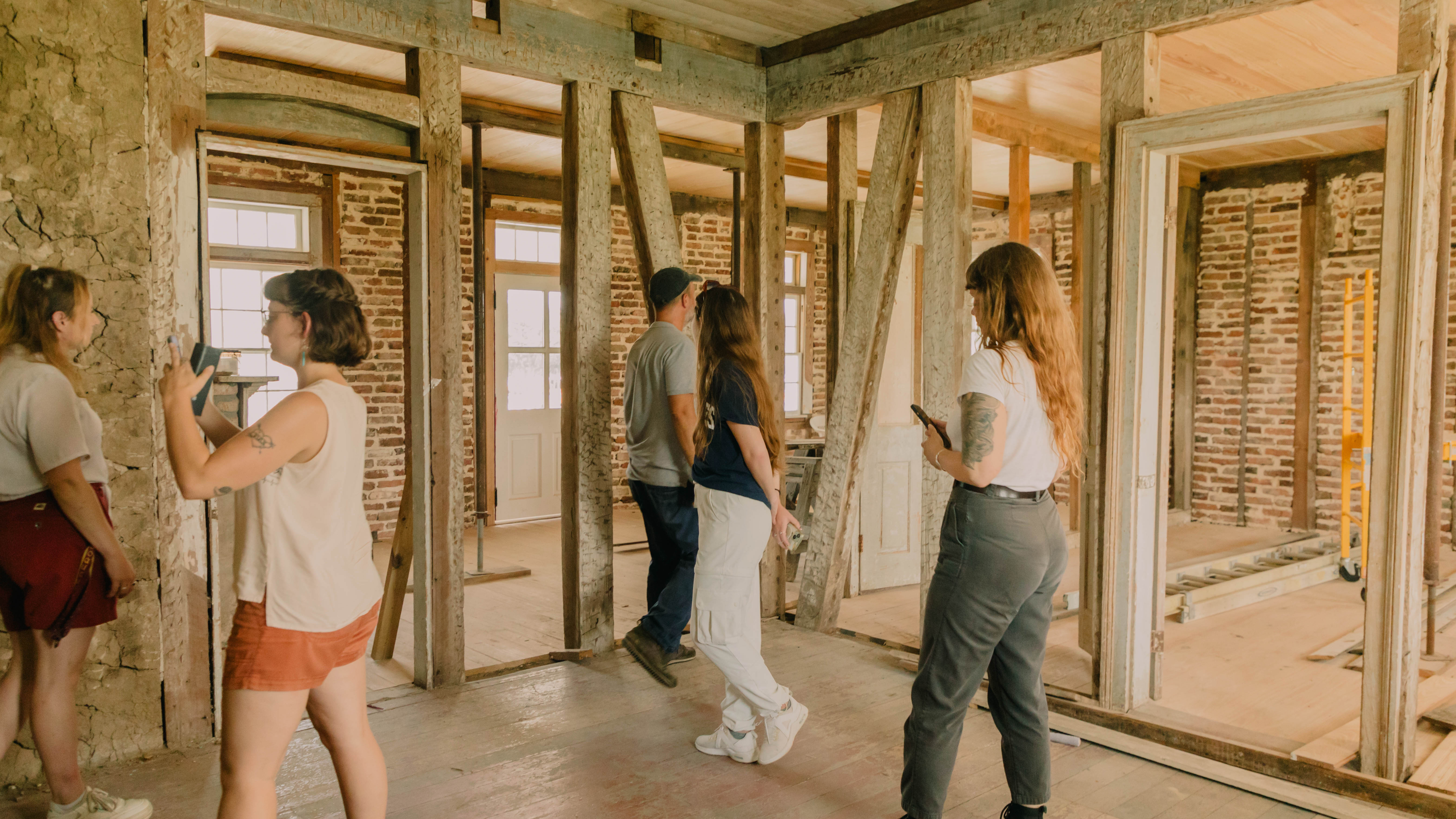 Image of students walking around pillars and foundations of a building