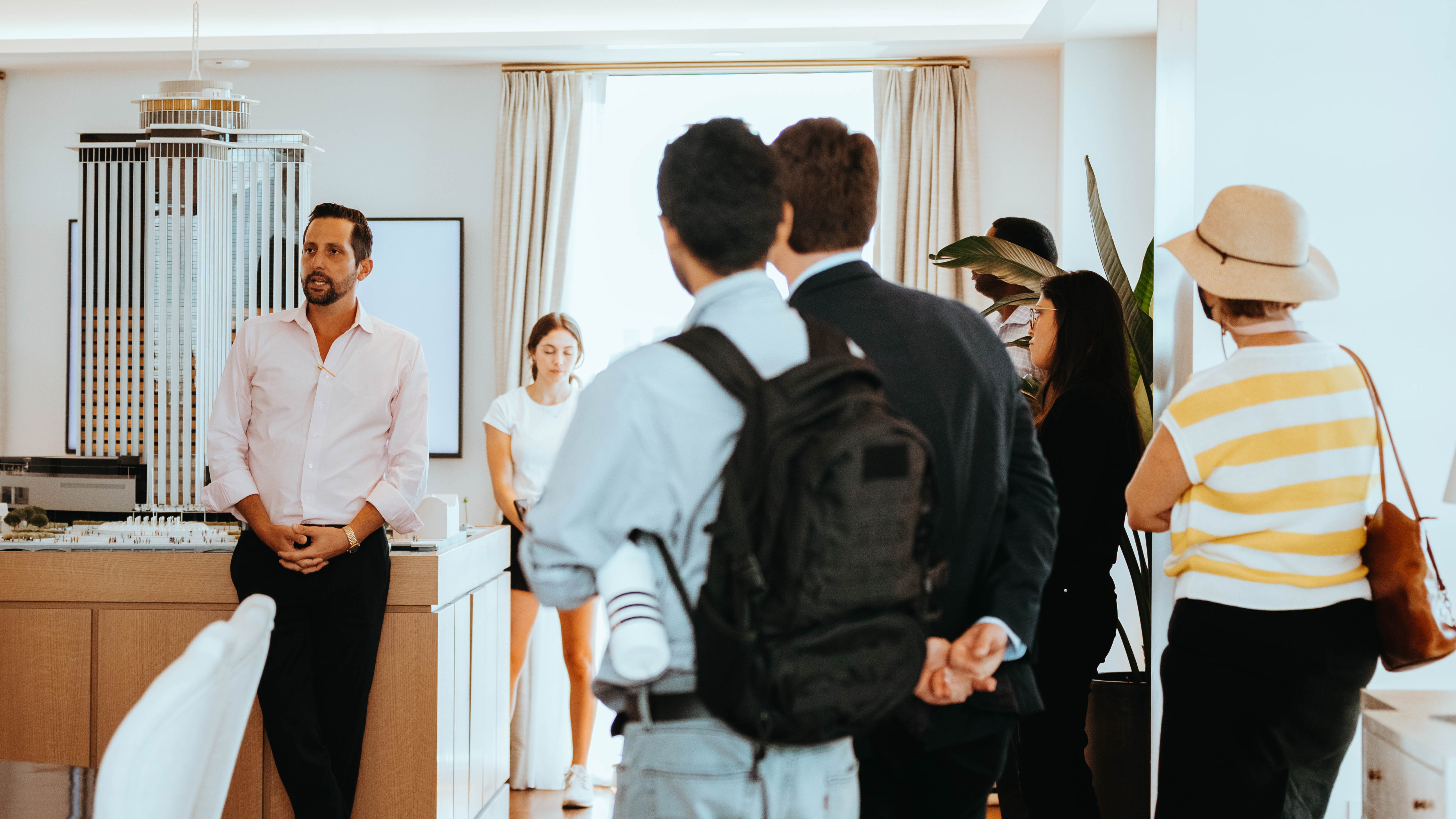 Image of open house and professor talking to students