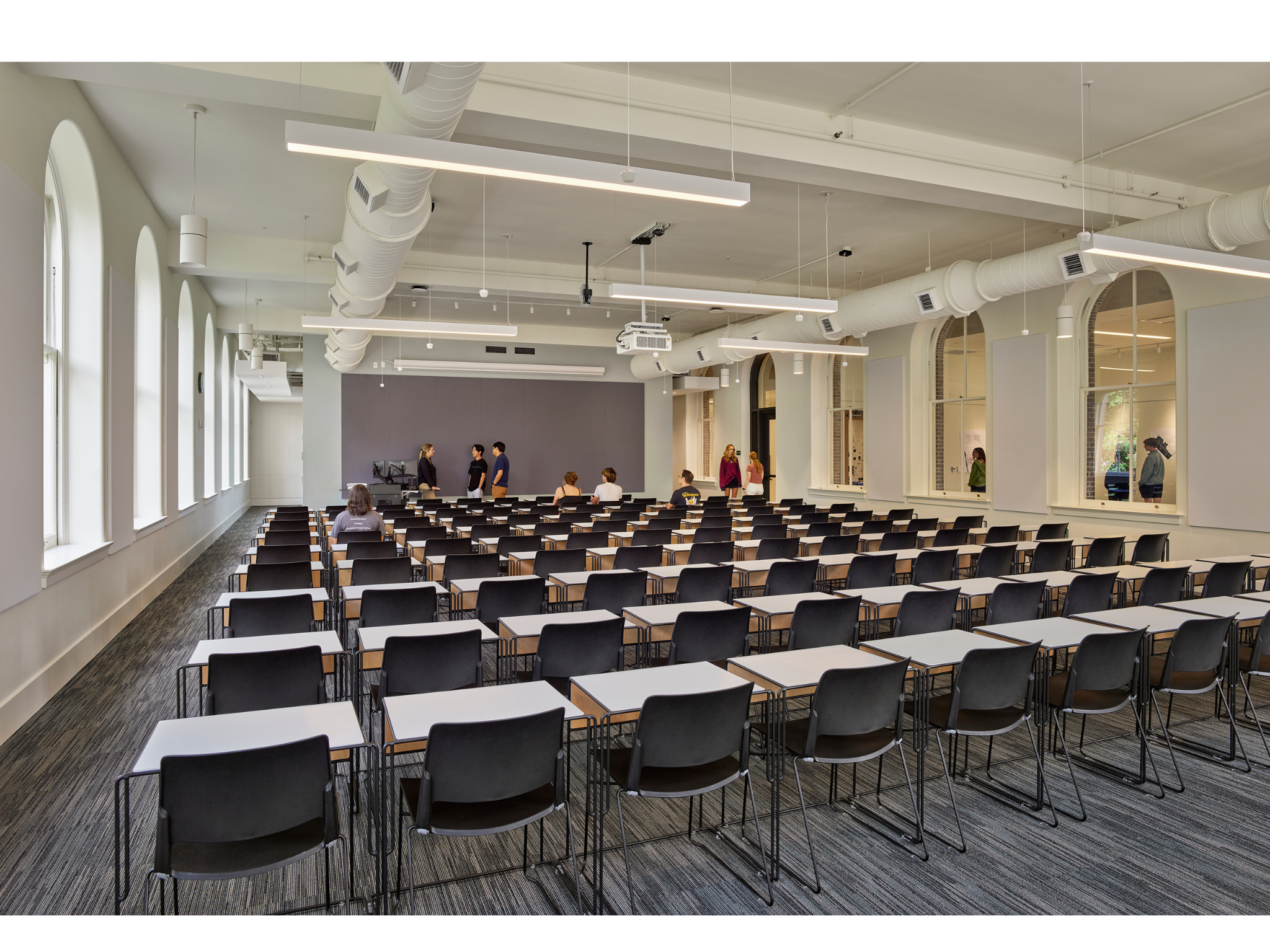 Inside corner view of Thomson Hall, a large lecture hall with movable desks and chairs.