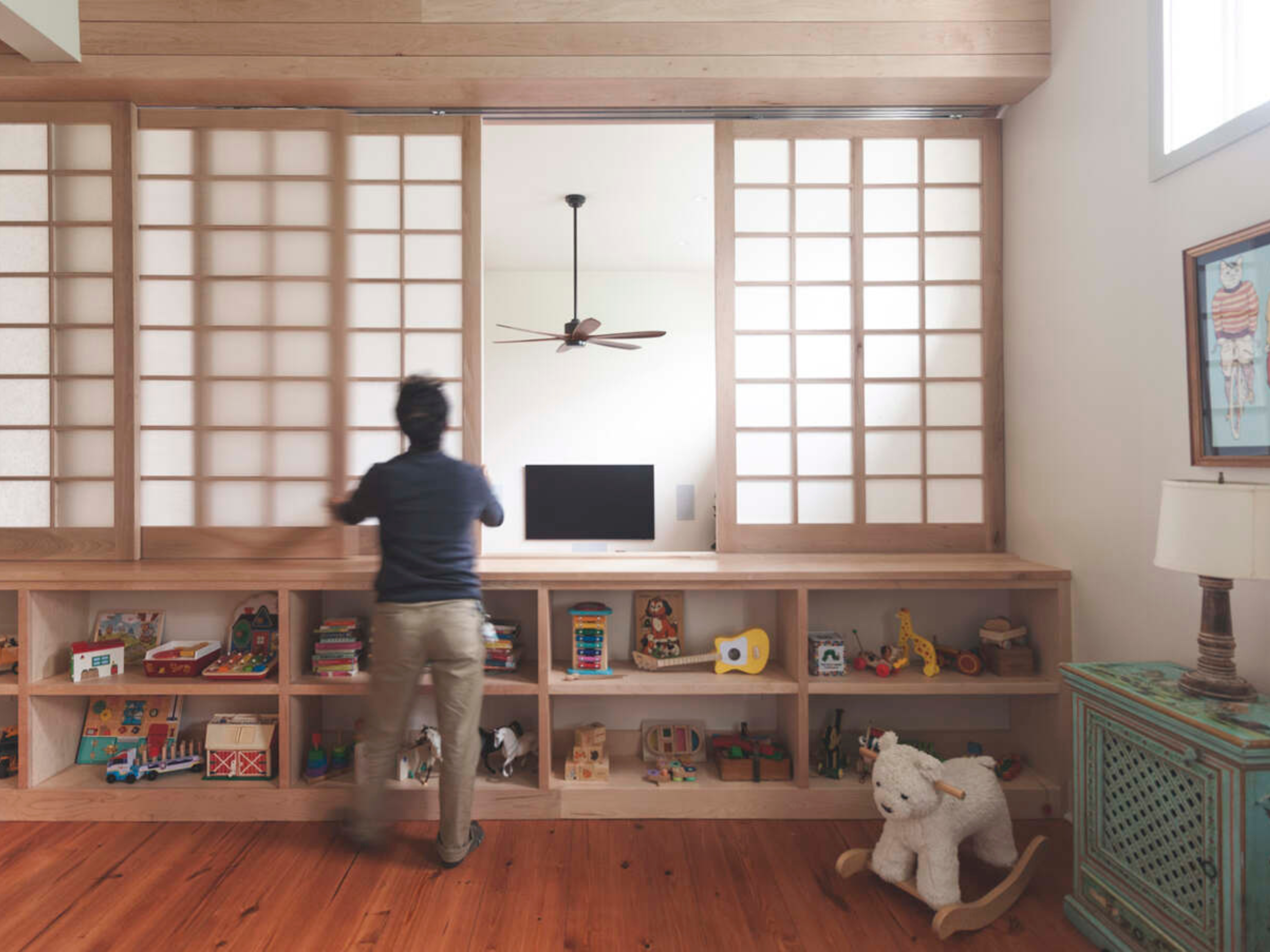 view of a wooden, built-in sliding screen divider in a residential home.