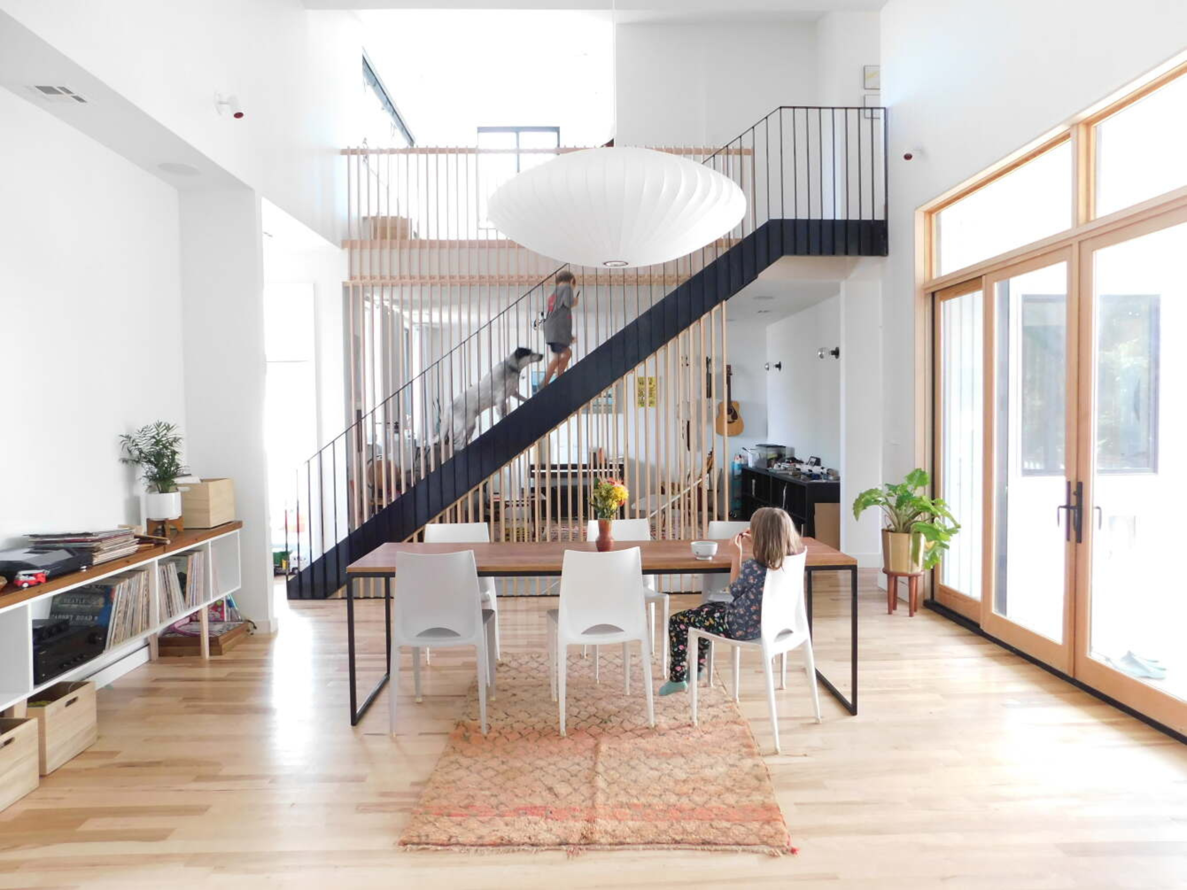 Interior view of single-family home dining room with a open staircase in the background.