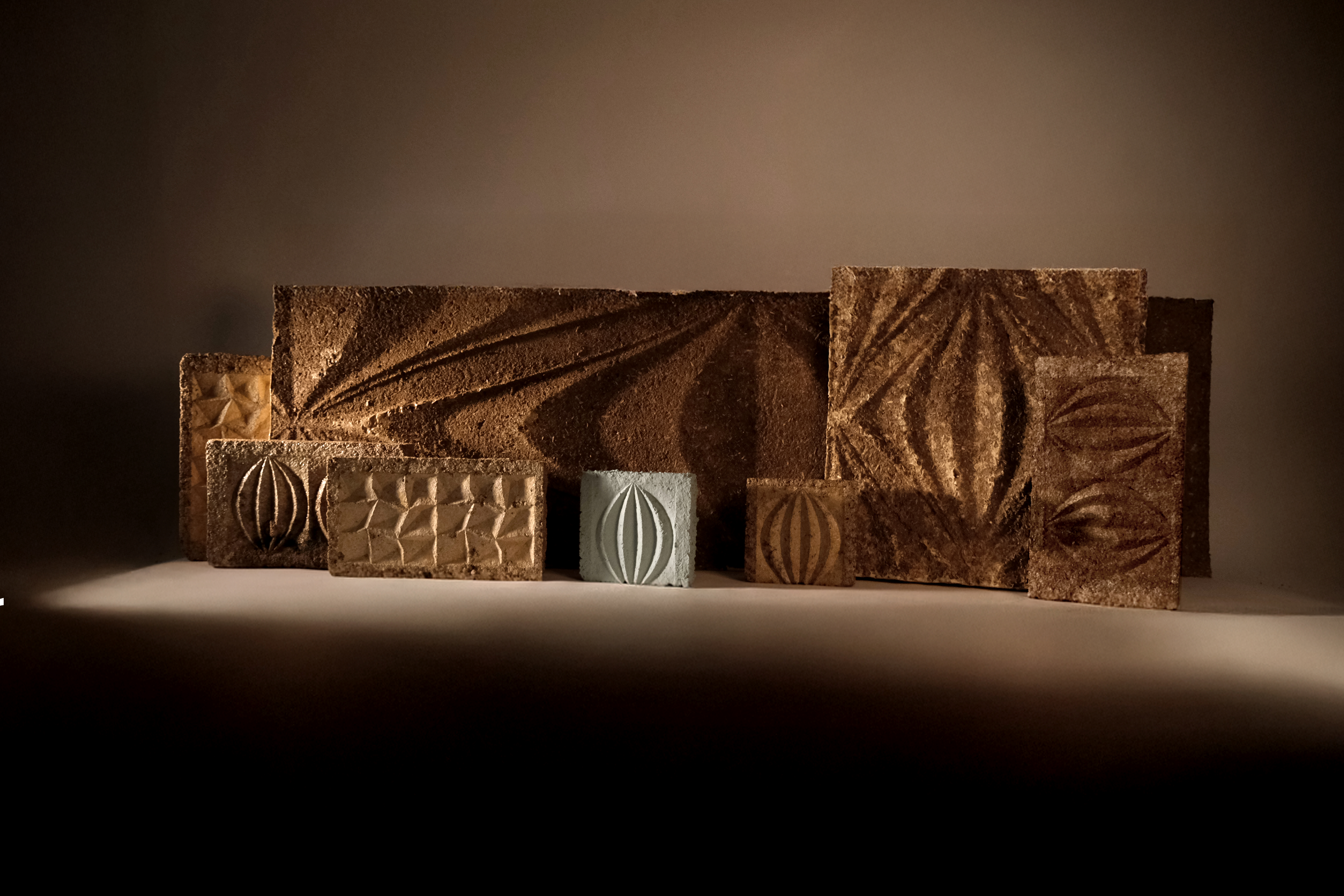 Several pieces of mycelium materials stand up on display.