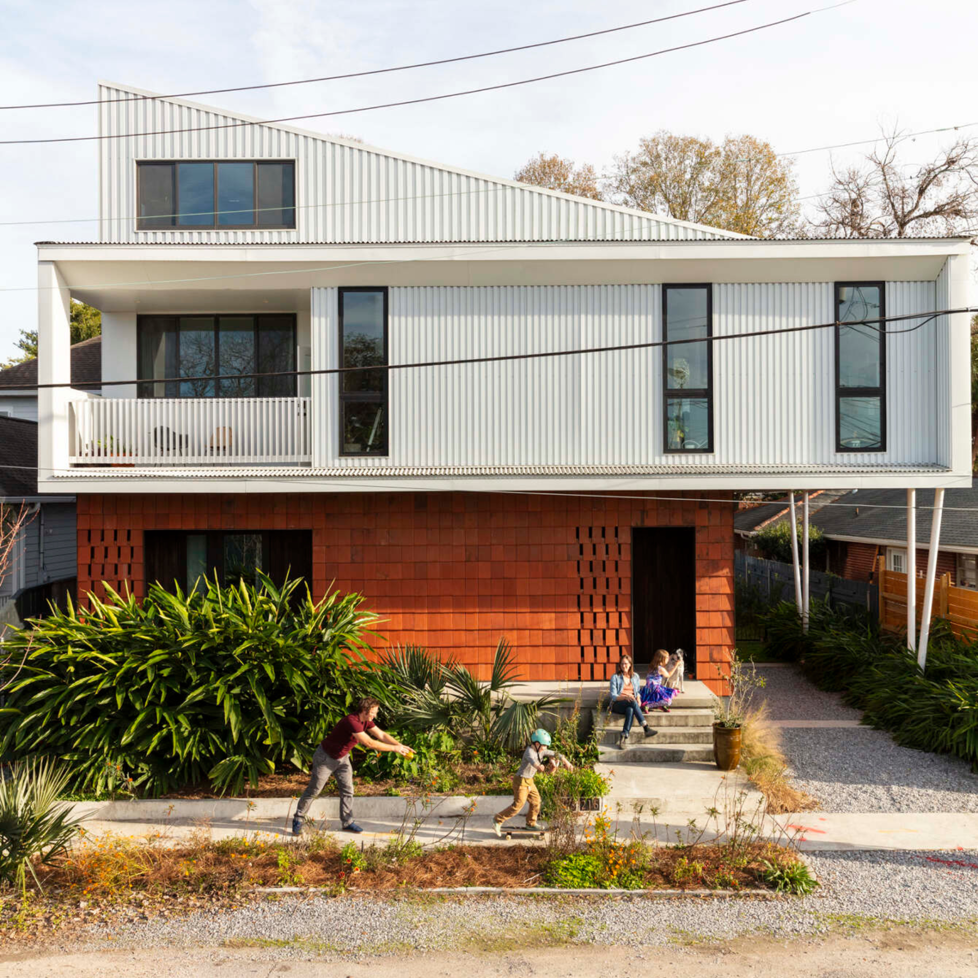 Exterior view of entire front facade of modern three-story home, designed by Colectivo.
