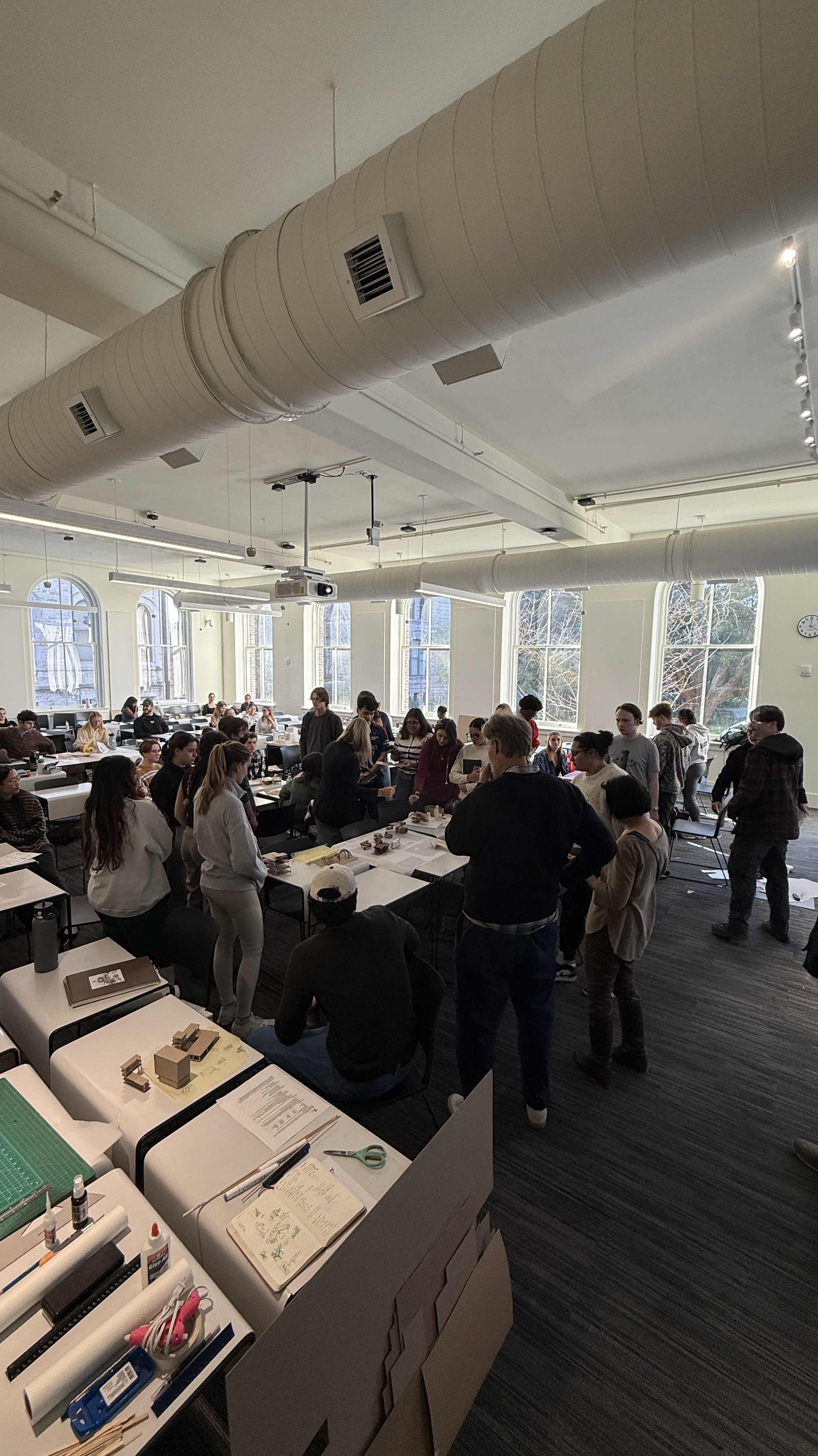 Students work in the large lecture hall of RMH