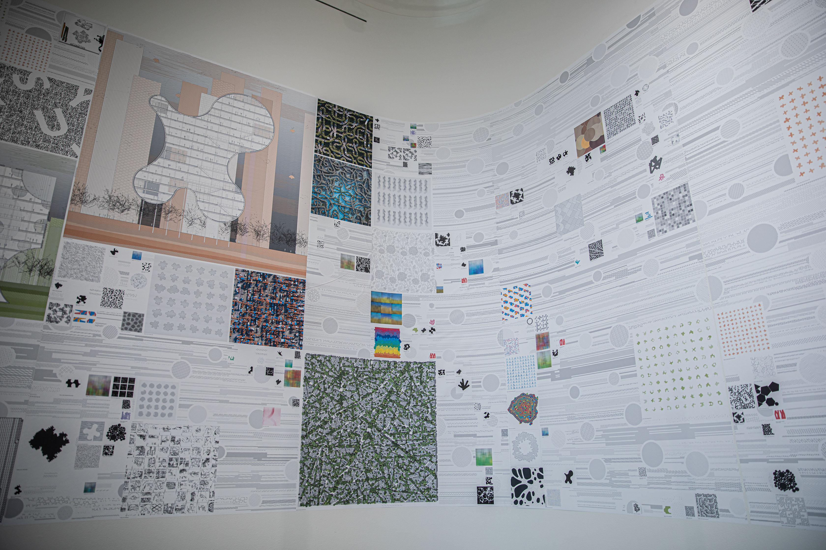 Close-up picture of some of the exhibit's drawings and computational models on the wall