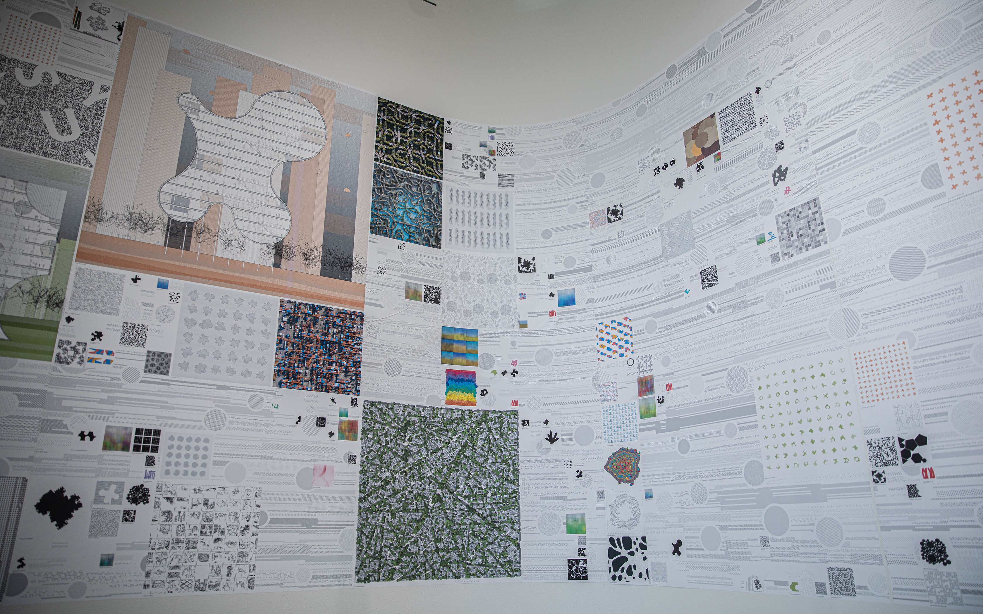 Close-up picture of some of the exhibit's drawings and computational models on the wall