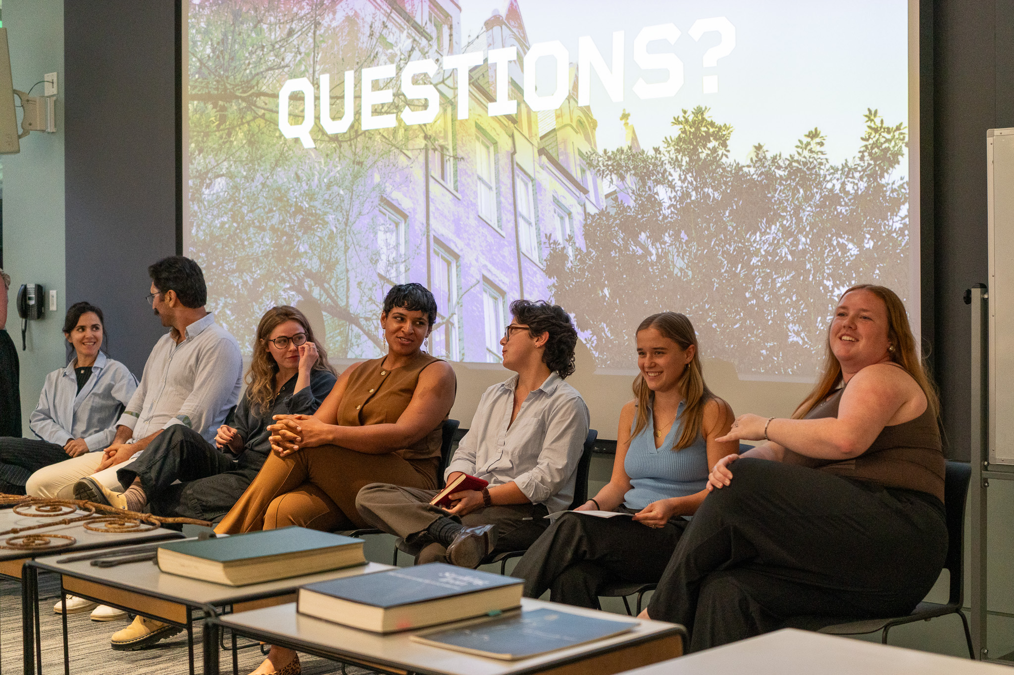 Students sit in front of a presentation answering questions