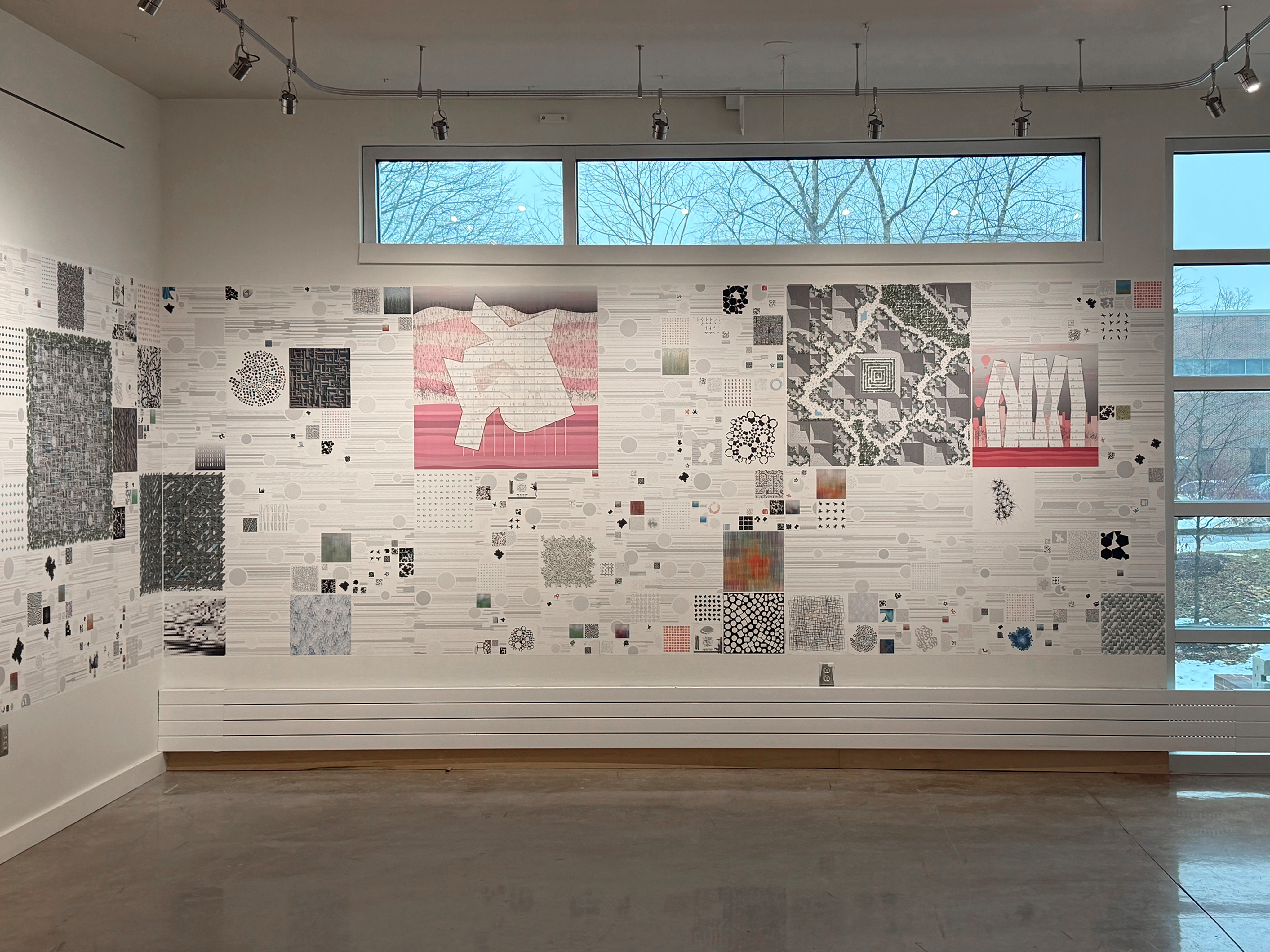 Picture of Adam Marcus's exhibit, showing drawings and plans on wall with windows above and to the right