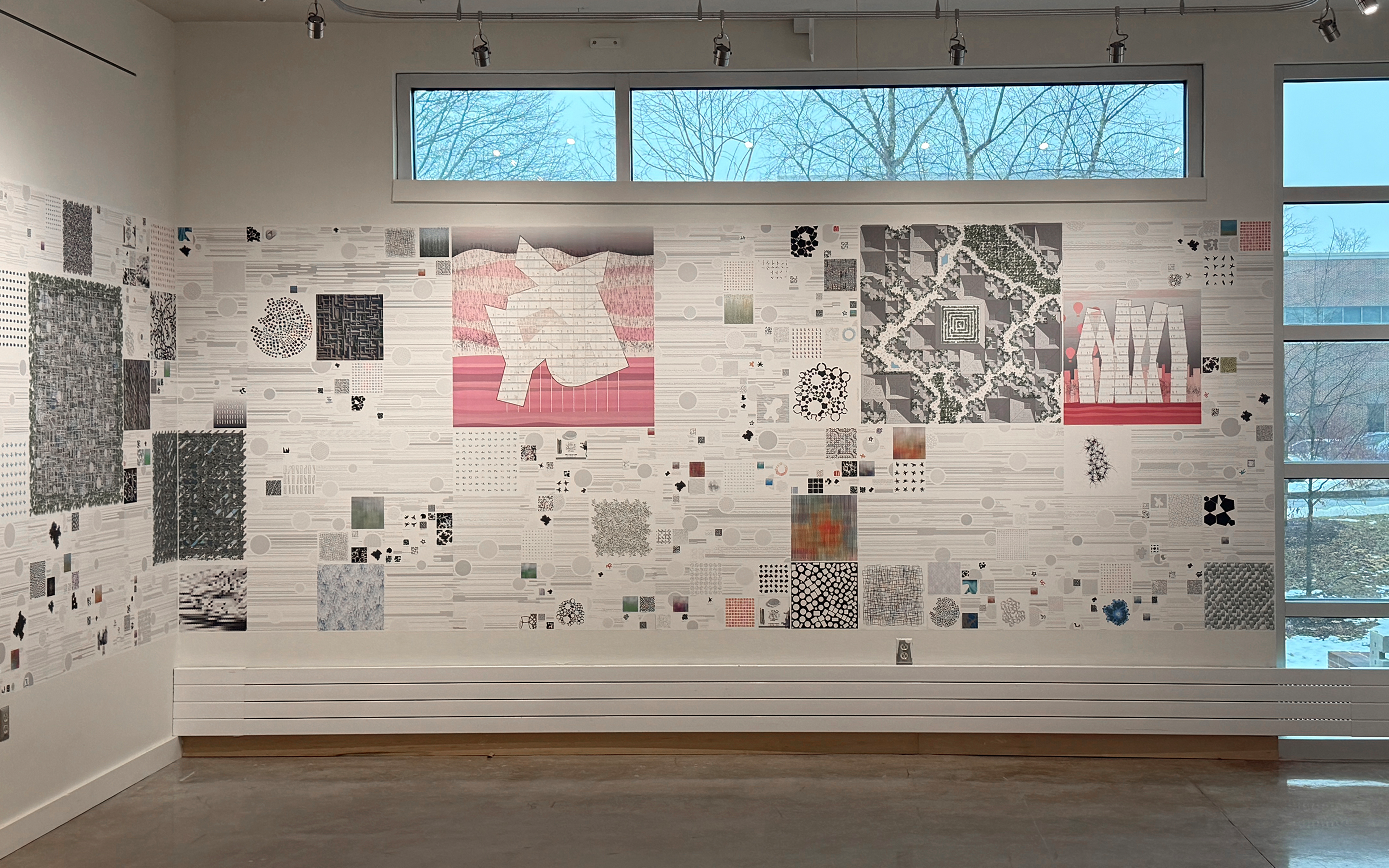 Picture of Adam Marcus's exhibit, showing drawings and plans on wall with windows above and to the right