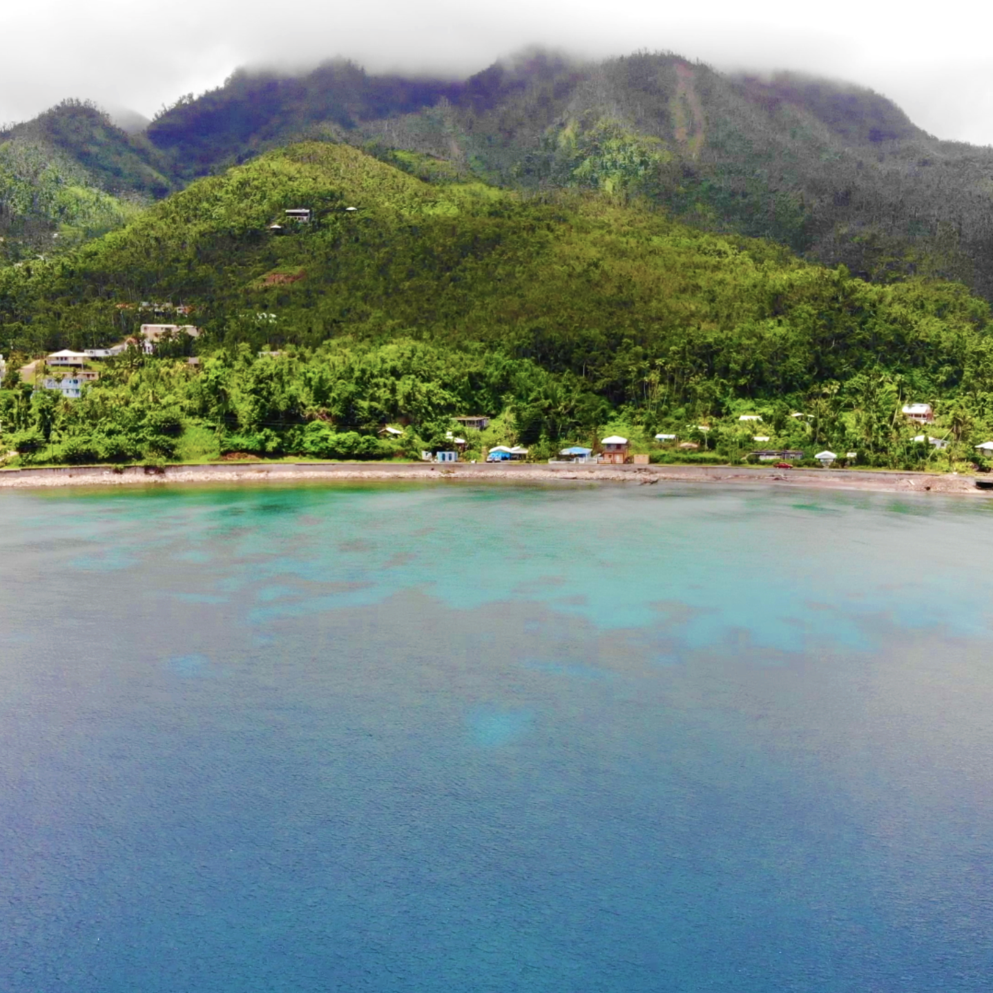 scenic photo of water, a beach, and mountains
