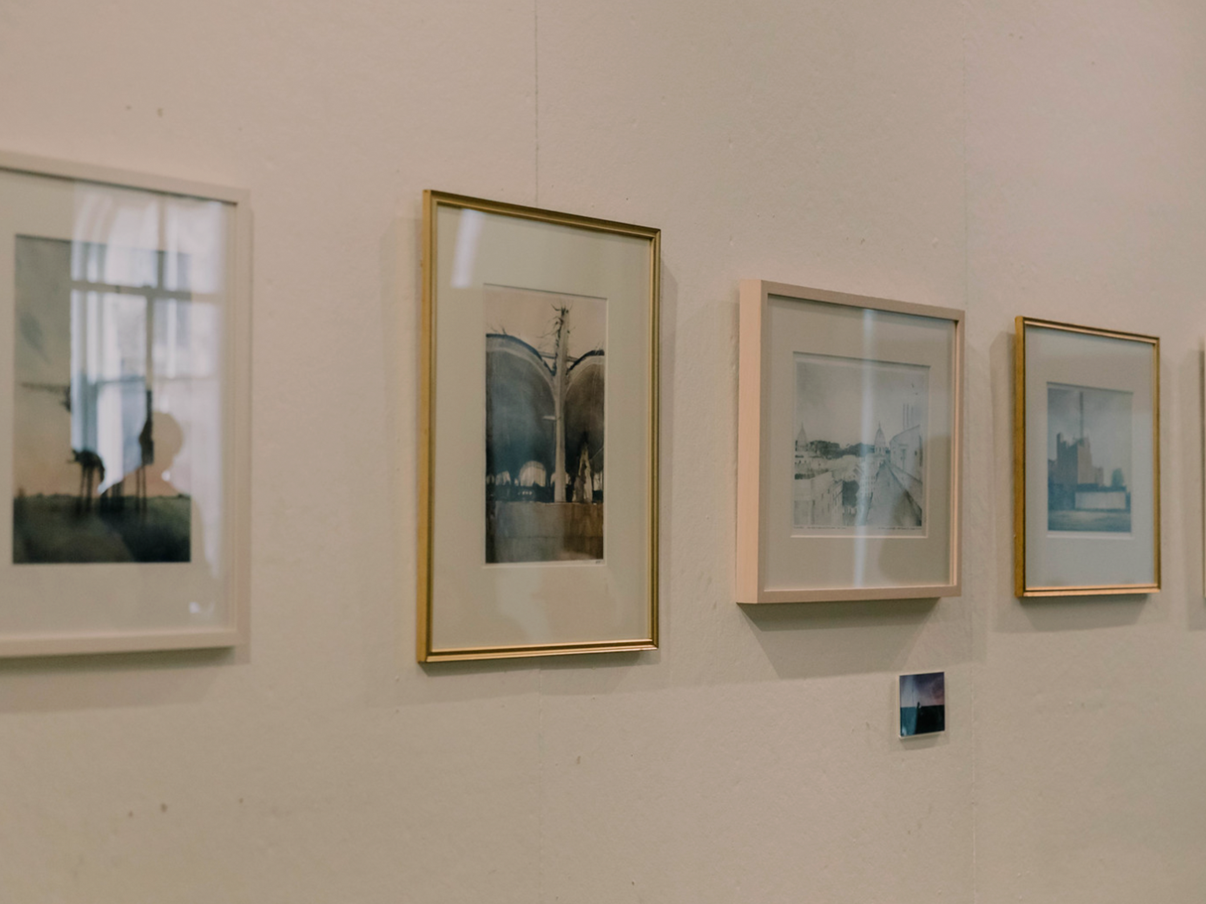 Close up of framed paintings hanging on wall