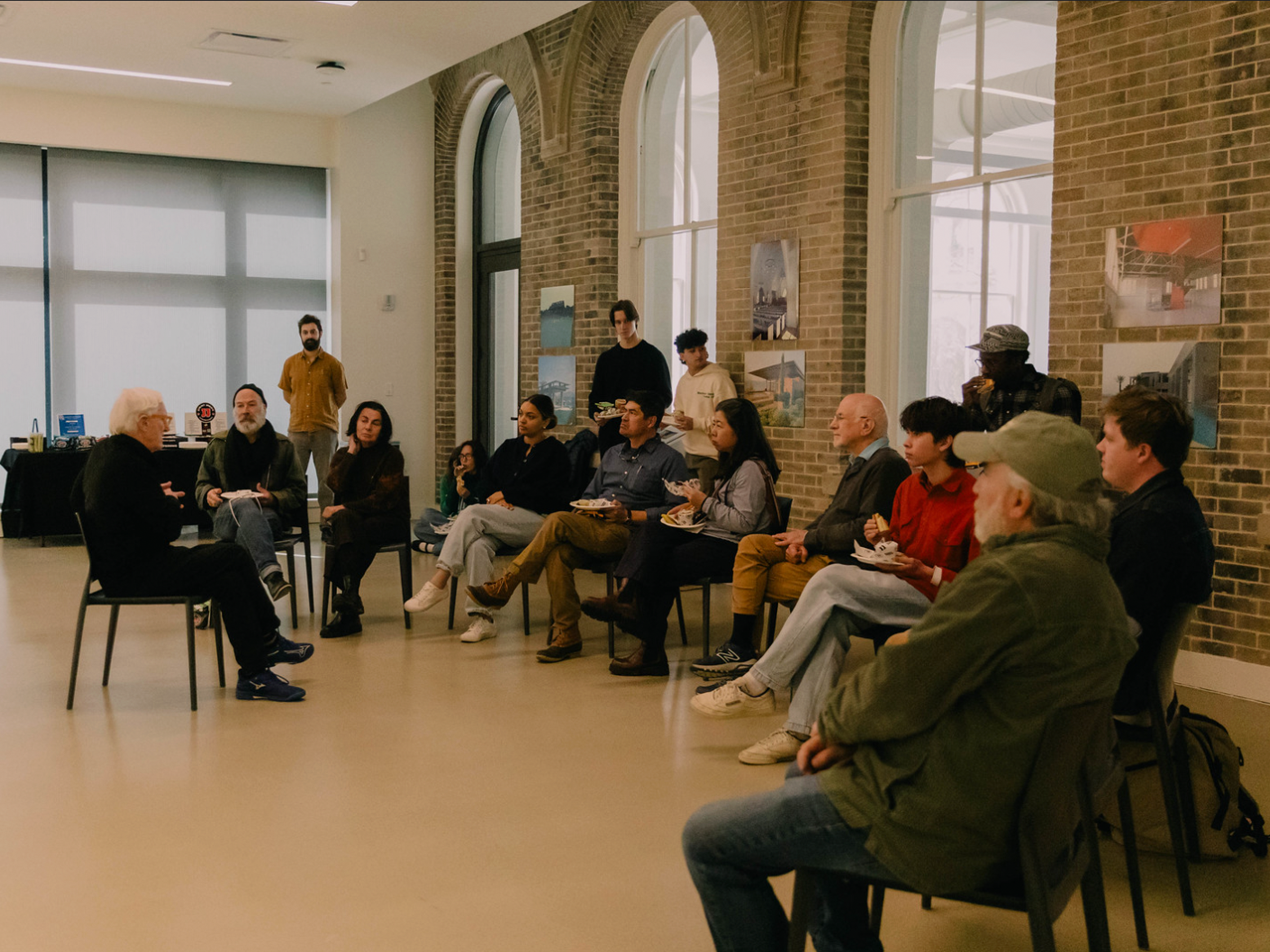 Errol Baron speaking to a small seated crowd