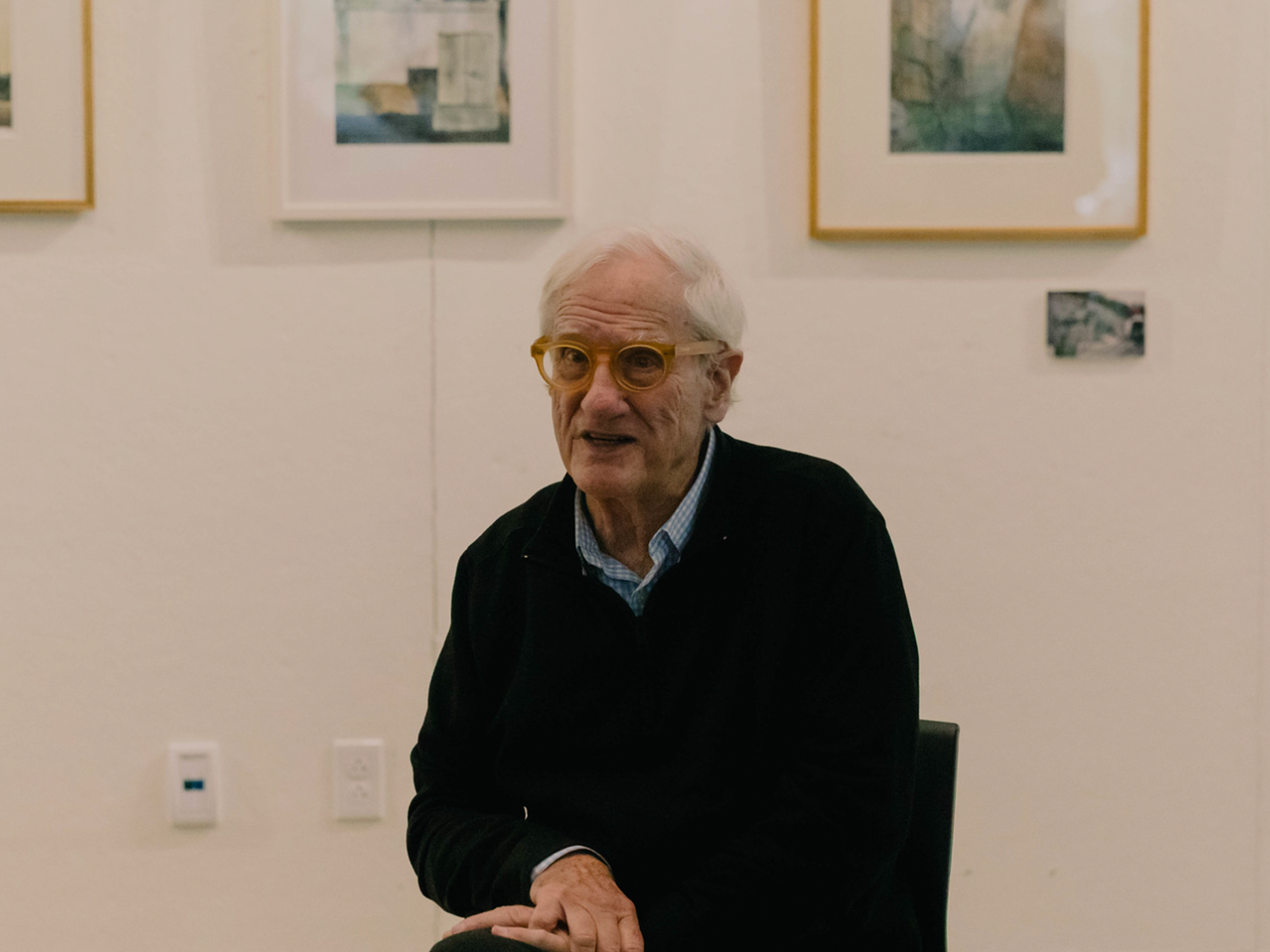 Close up of Errol Baron in front of paintings