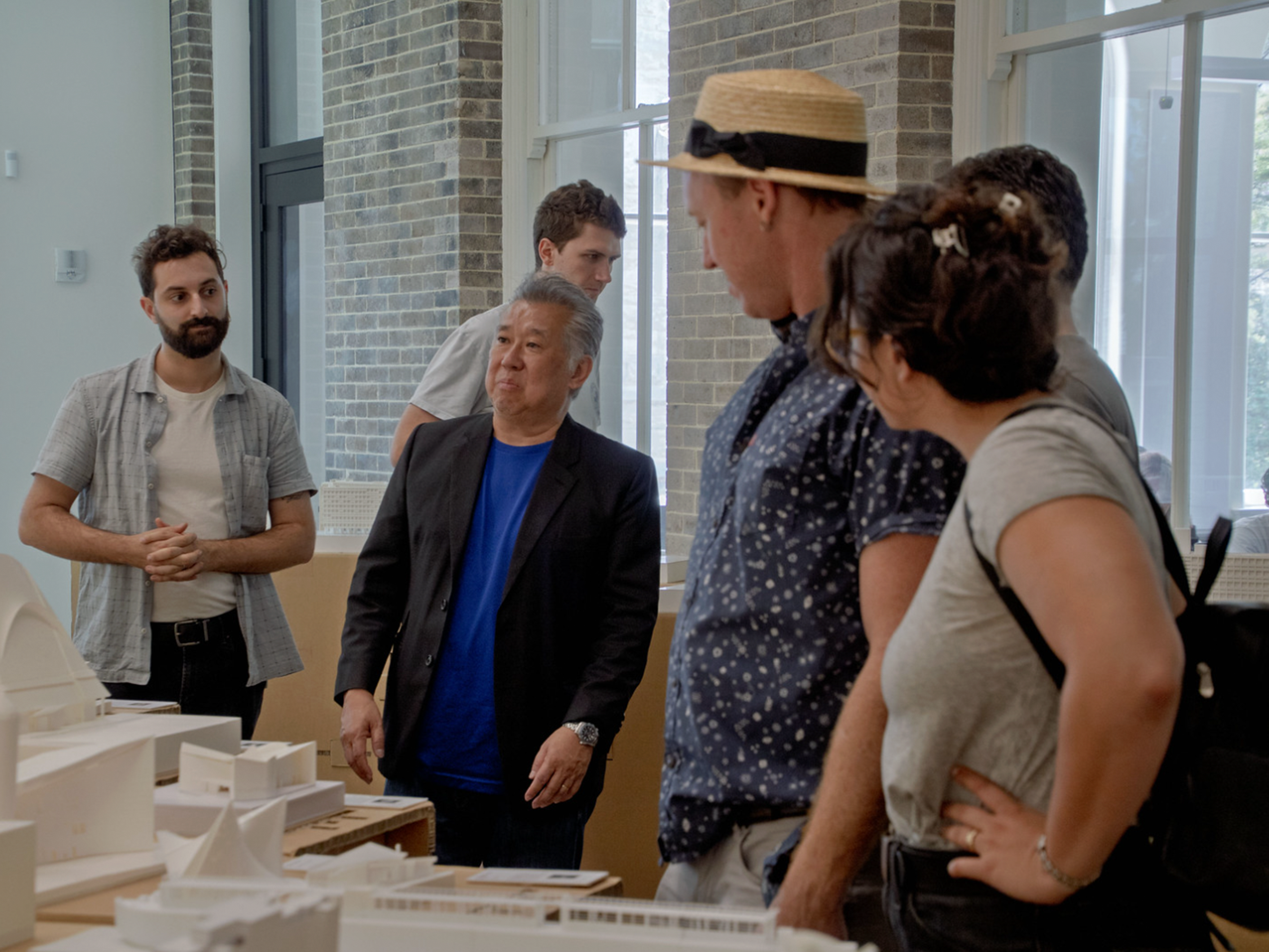 Presenters and audience considering models in front of them