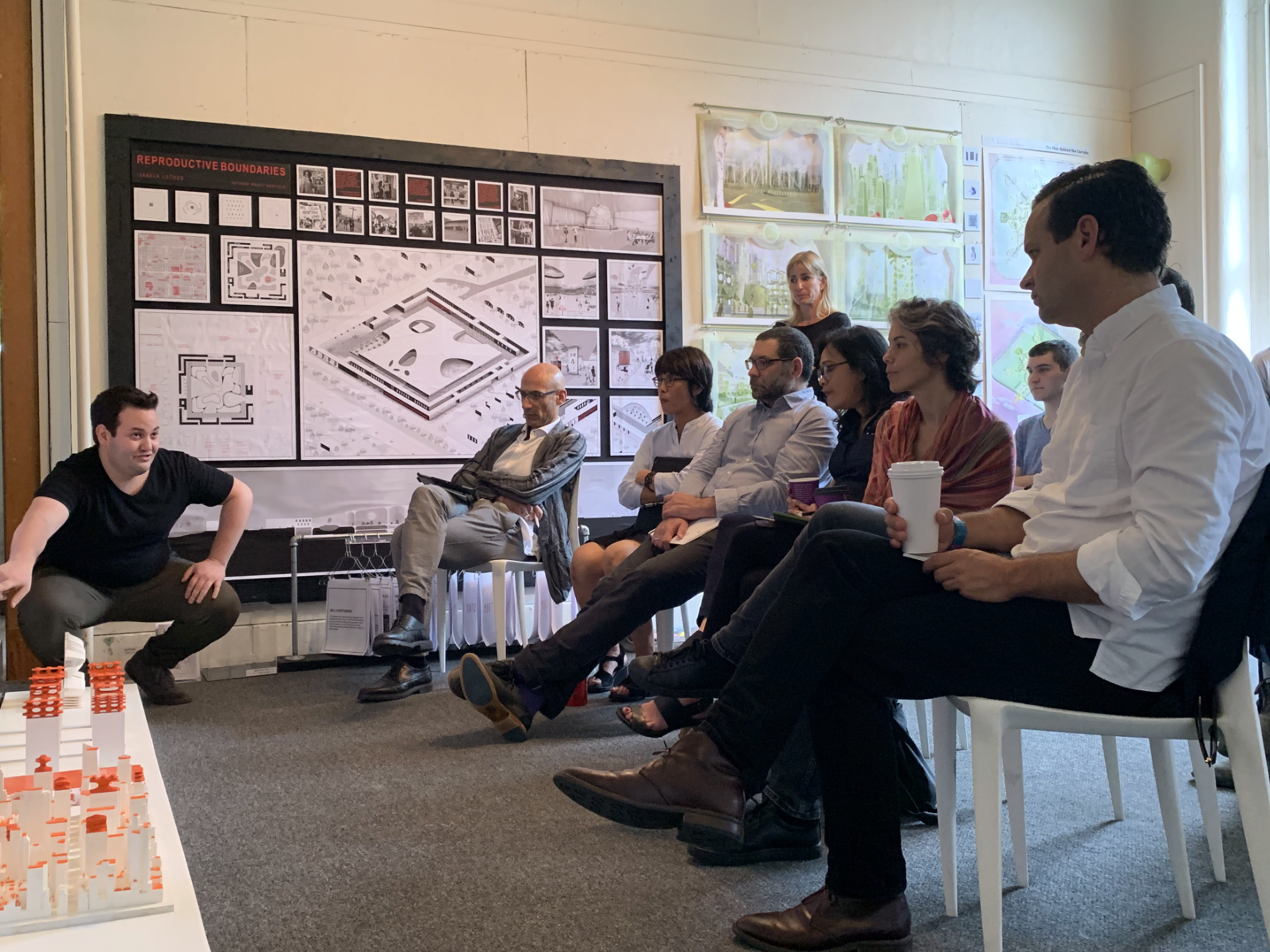 Presenter crouching down to show audience his model