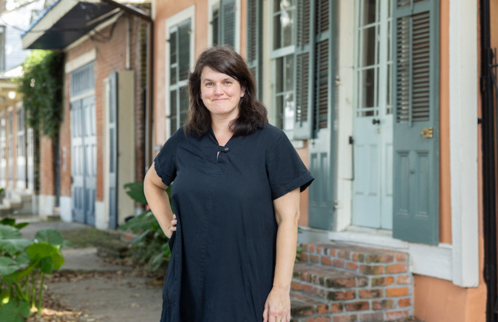 Heather Veneziano, program director for historic preservation and professor of practice in Tulane University's School of Architecture and Built Environment, stands in front of historic shotgun houses in New Orleans' Tremé neighborhood. The city's distinctive vernacular architecture helped secure New Orleans' place on the World Monuments Fund's inaugural "Irreplaceable America" list. (Photo by Kenny Lass)