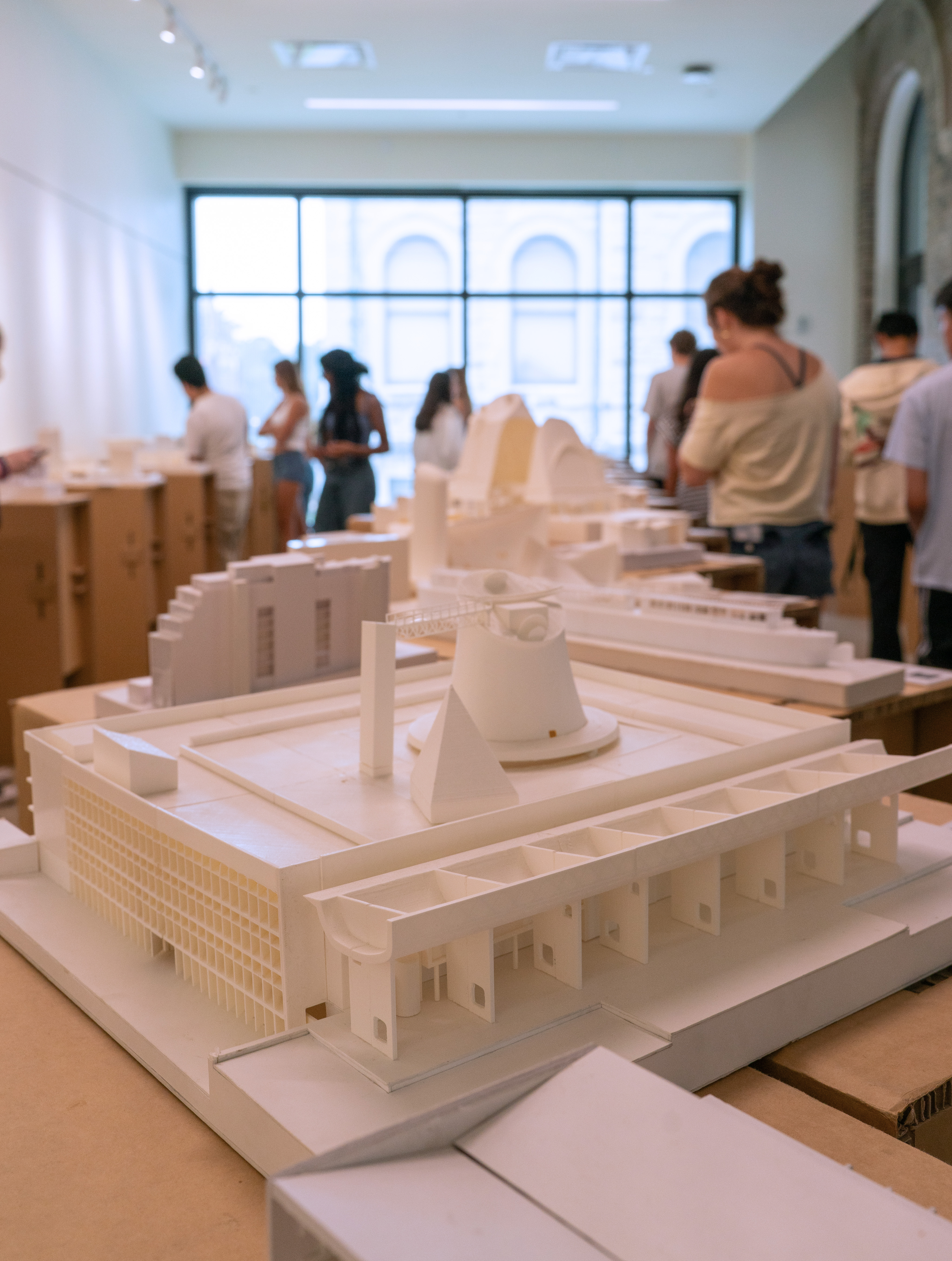 Le Corbusier models on display in a gallery.