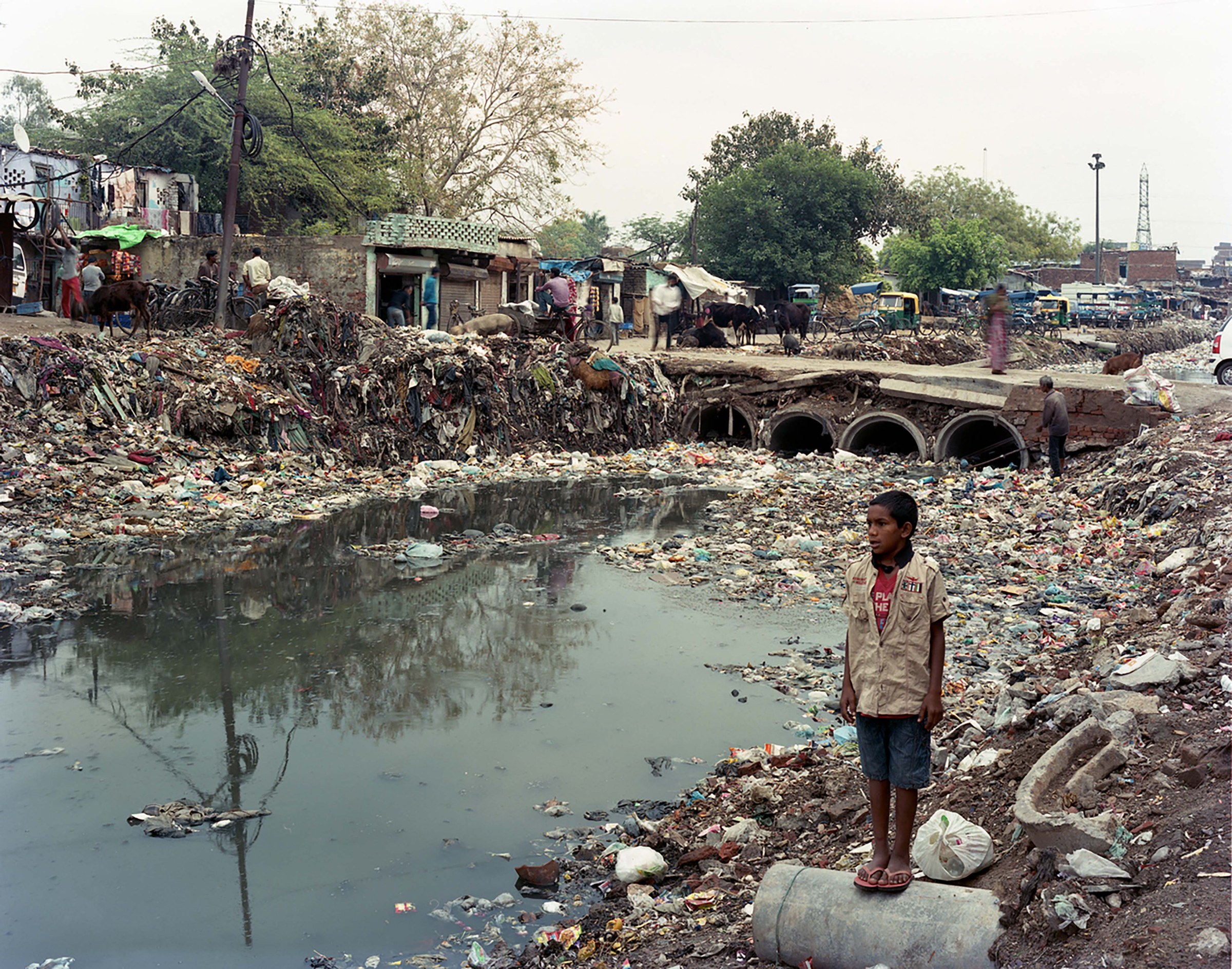 Photo of child standing besides the Yamuna River