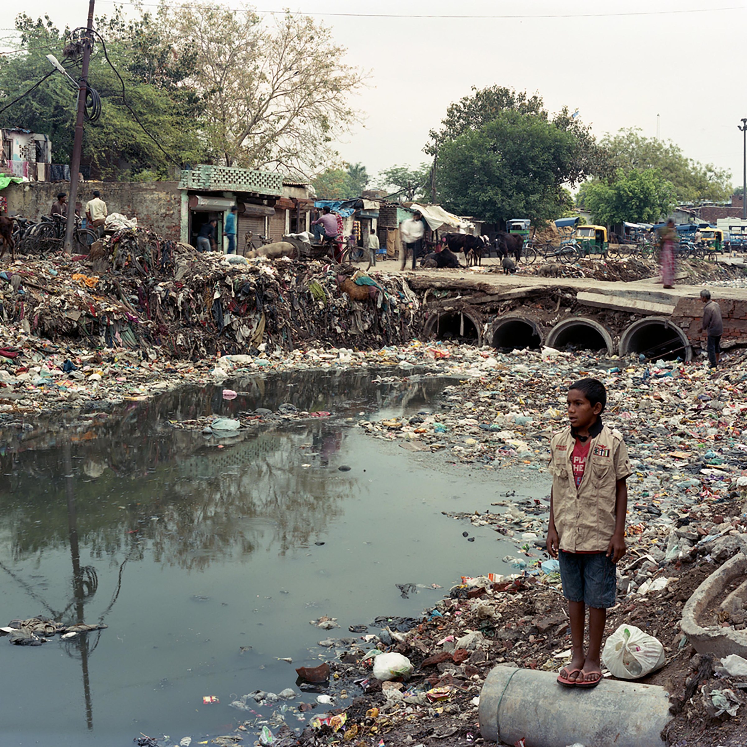 Photo of child standing besides the Yamuna River