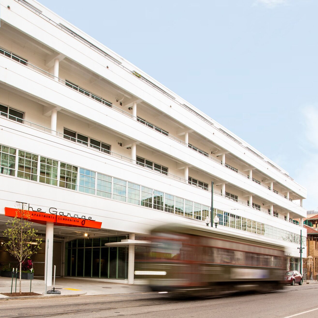 Exterior of "The Garage" with streetcar speeding by 