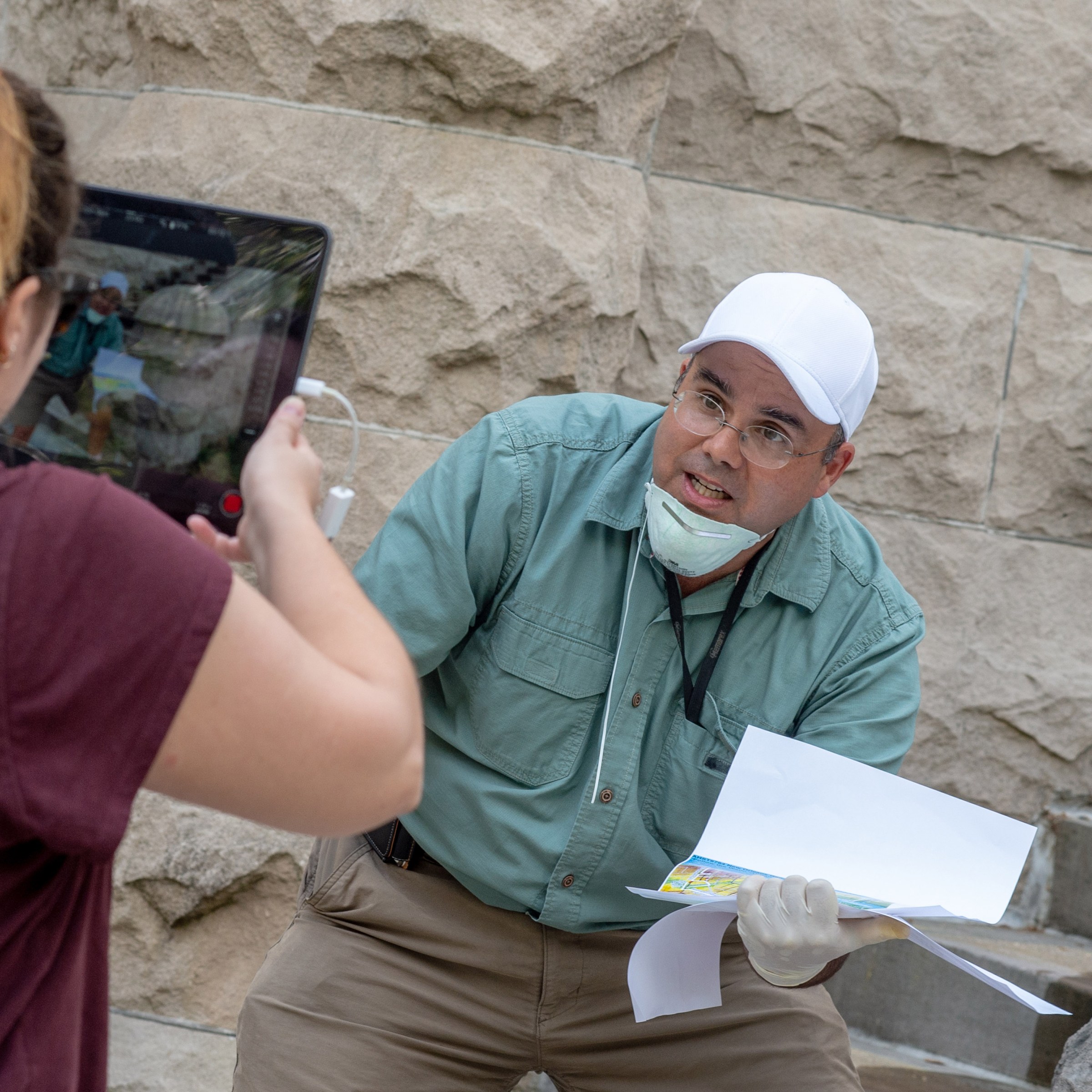 Photo of Professor Campanella explaining something to a woman holding a screen recording him